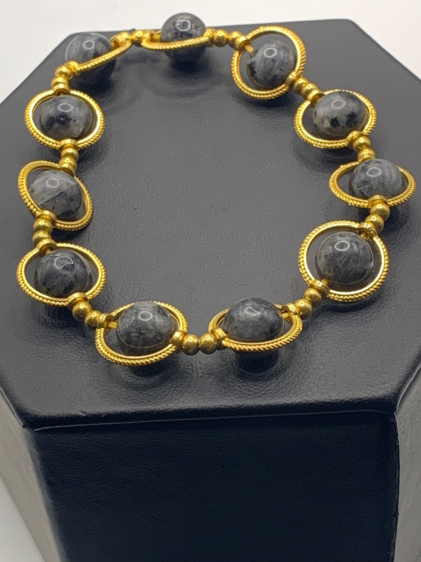 Larvikite semi precious stone/crystal elastic beaded bracelet with gold colored rings