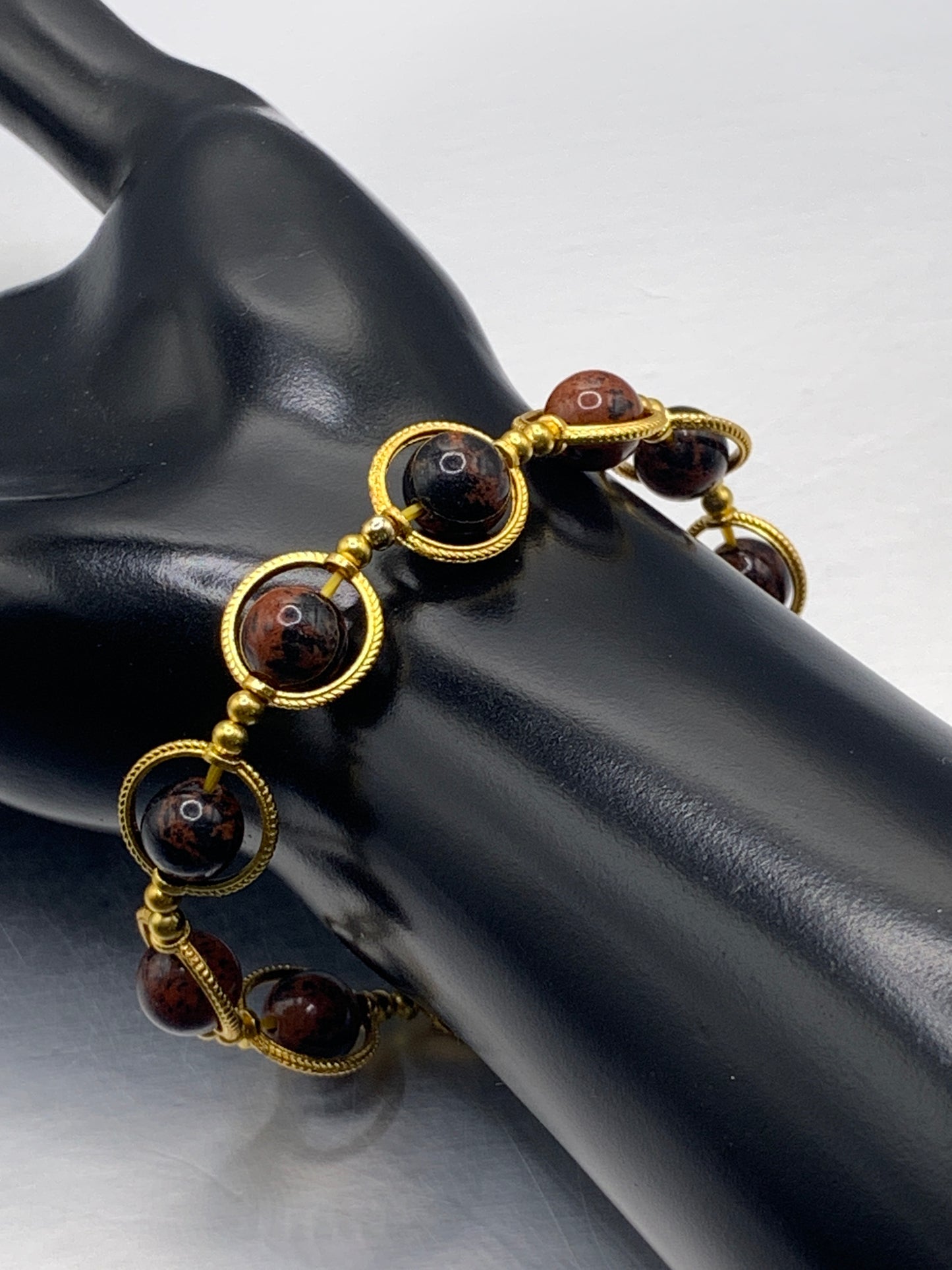 Mahogany jasper semi precious stone/crystal elastic beaded bracelet with gold colored rings