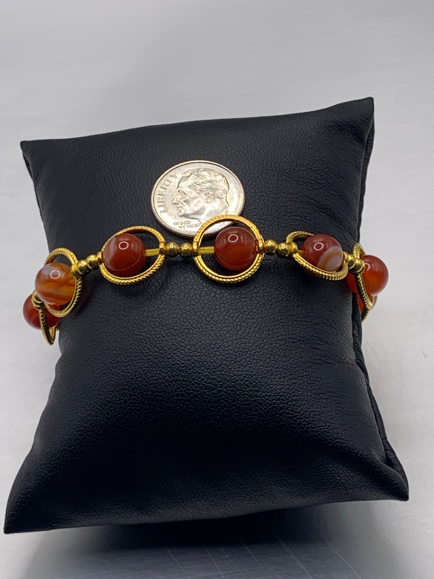 Red agate semi precious stone/crystal elastic beaded bracelet with gold colored rings