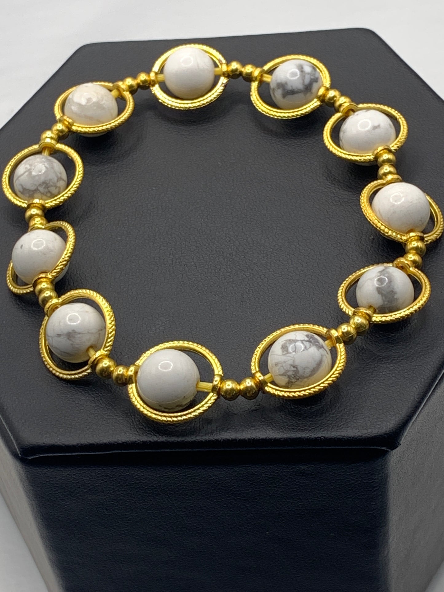 Howlite semi precious stone/crystal elastic beaded bracelet with gold colored rings