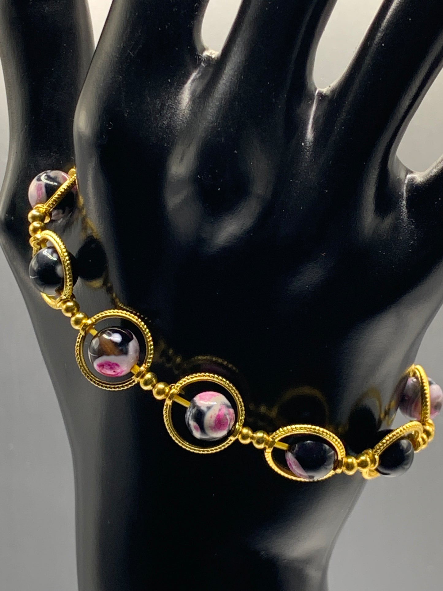 Pink orca agate semi precious stone/crystal elastic beaded bracelet with gold colored rings