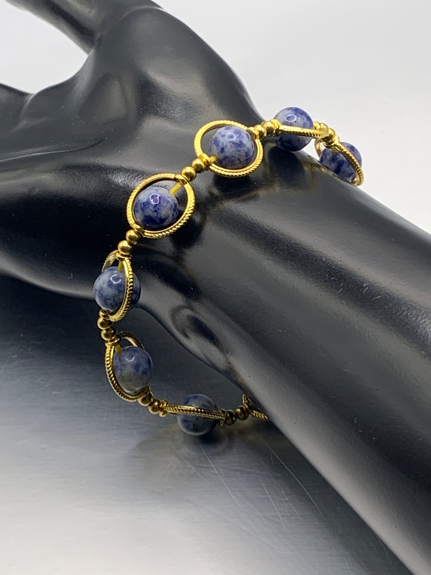 Blue dot jasper semi precious stone/crystal elastic beaded bracelet with gold colored rings