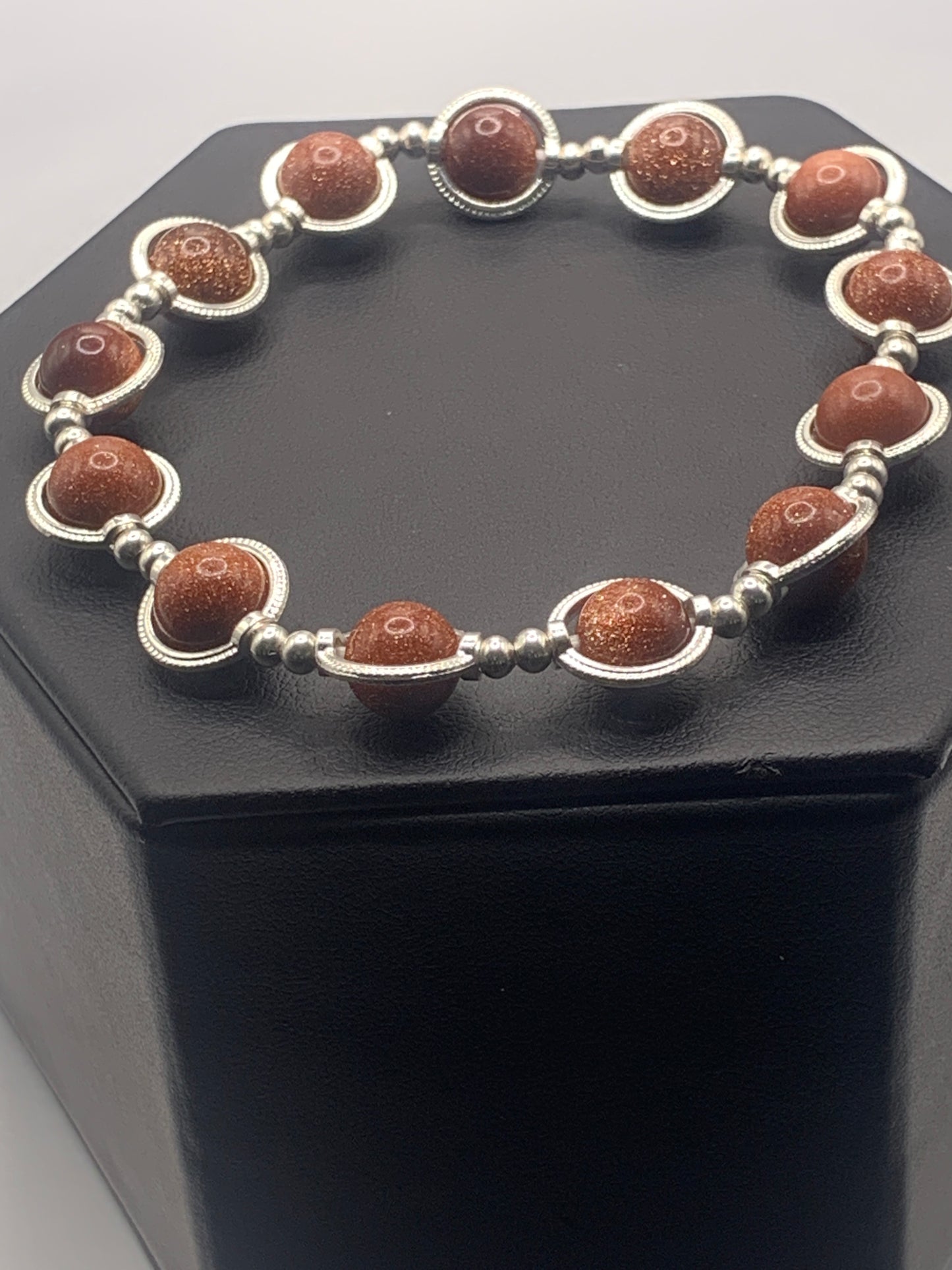 Sandstone semi precious stone/crystal elastic beaded bracelet with silver colored rings