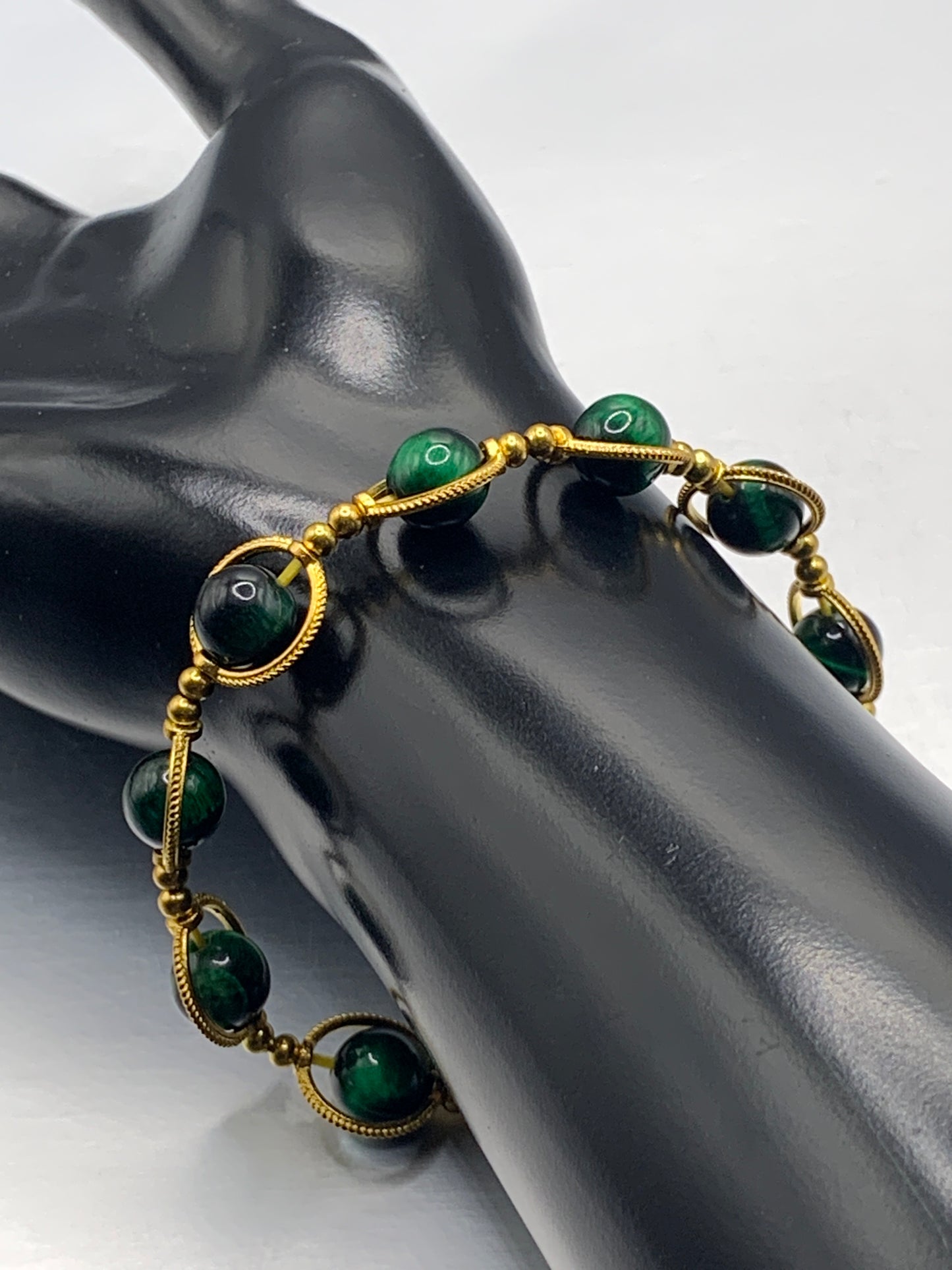 Green tigers eye semi precious stone/crystal elastic beaded bracelet with gold colored rings