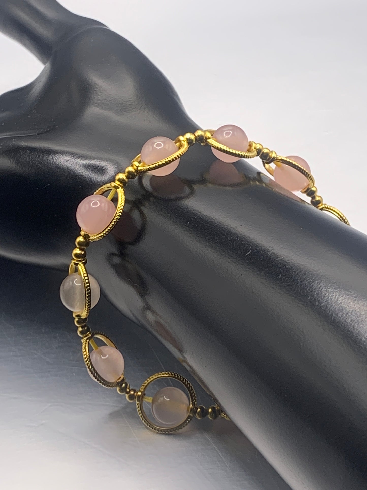 Rose quartz semi precious stone/crystal elastic beaded bracelet with gold colored rings
