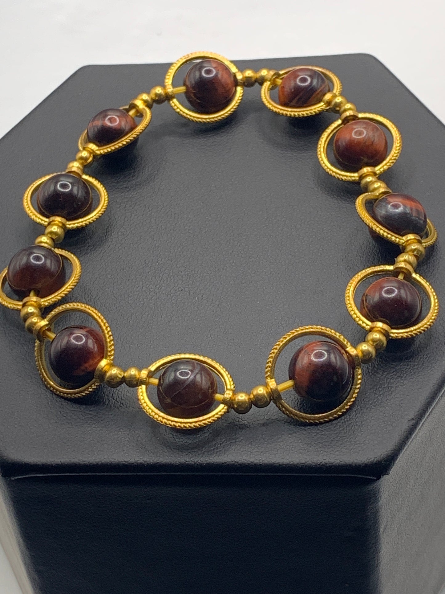 Red tigers eye semi precious stone/crystal elastic beaded bracelet with gold colored rings