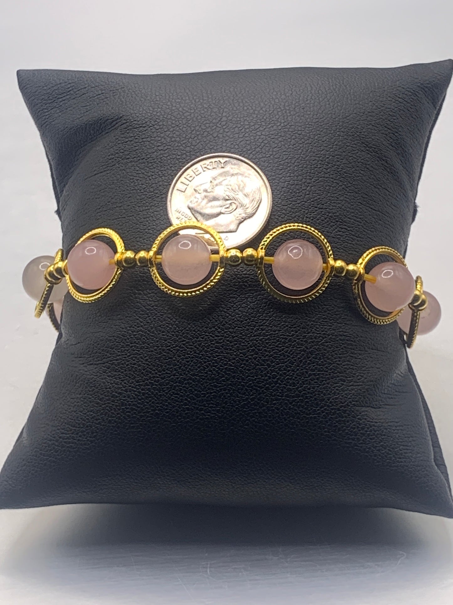 Rose quartz semi precious stone/crystal elastic beaded bracelet with gold colored rings