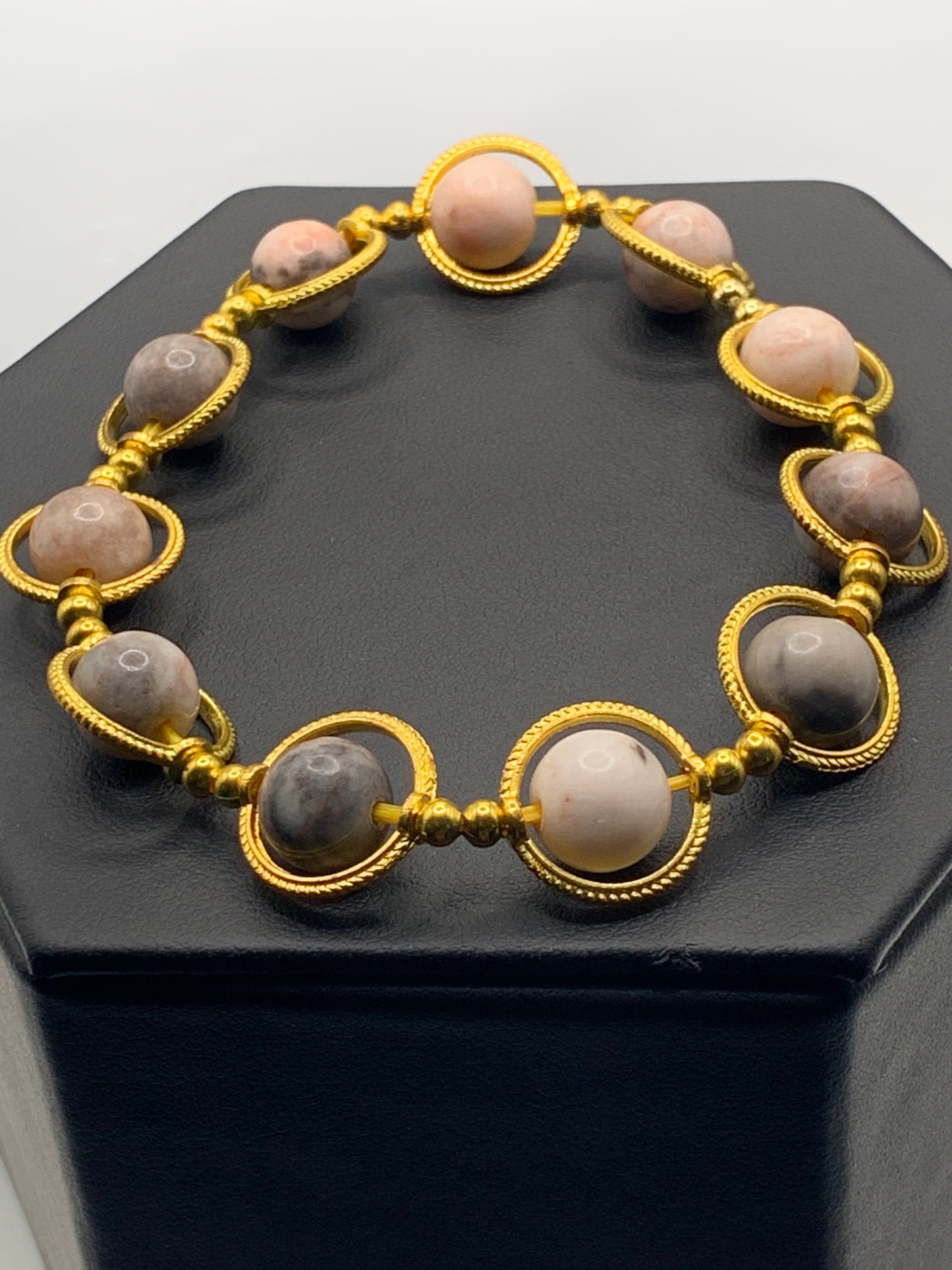 Pink zebra jasper semi precious stone/crystal elastic beaded bracelet with gold colored rings