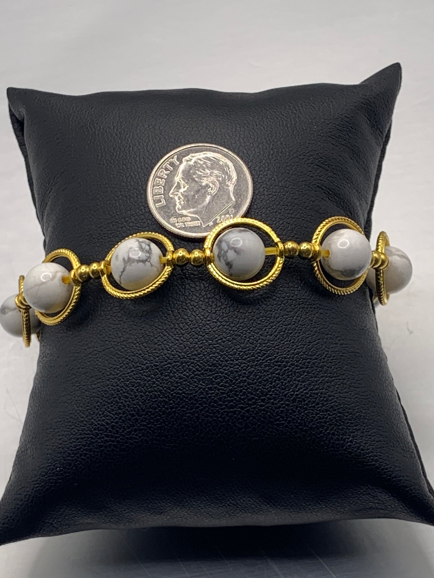 Howlite semi precious stone/crystal elastic beaded bracelet with gold colored rings
