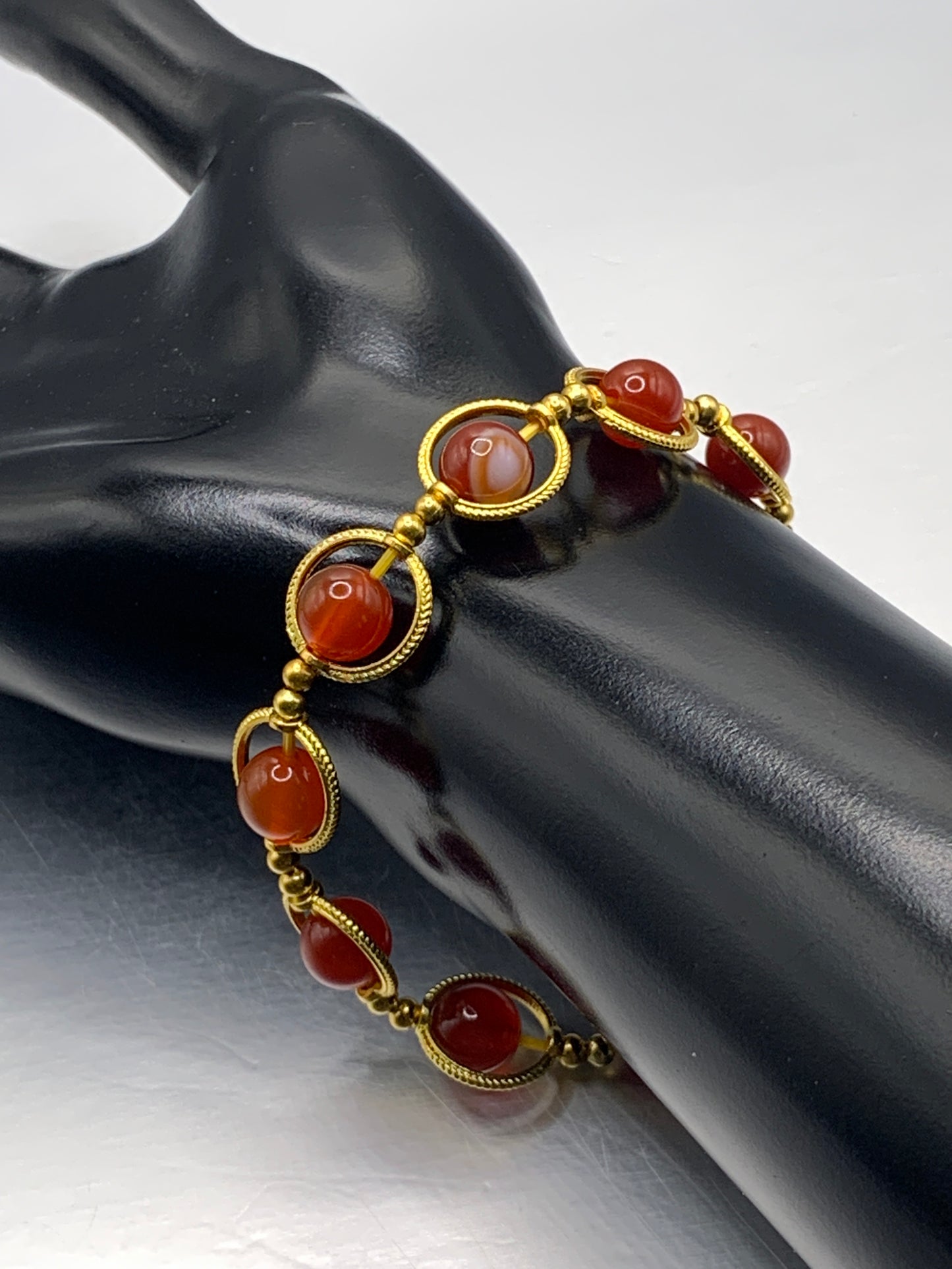 Red agate semi precious stone/crystal elastic beaded bracelet with gold colored rings