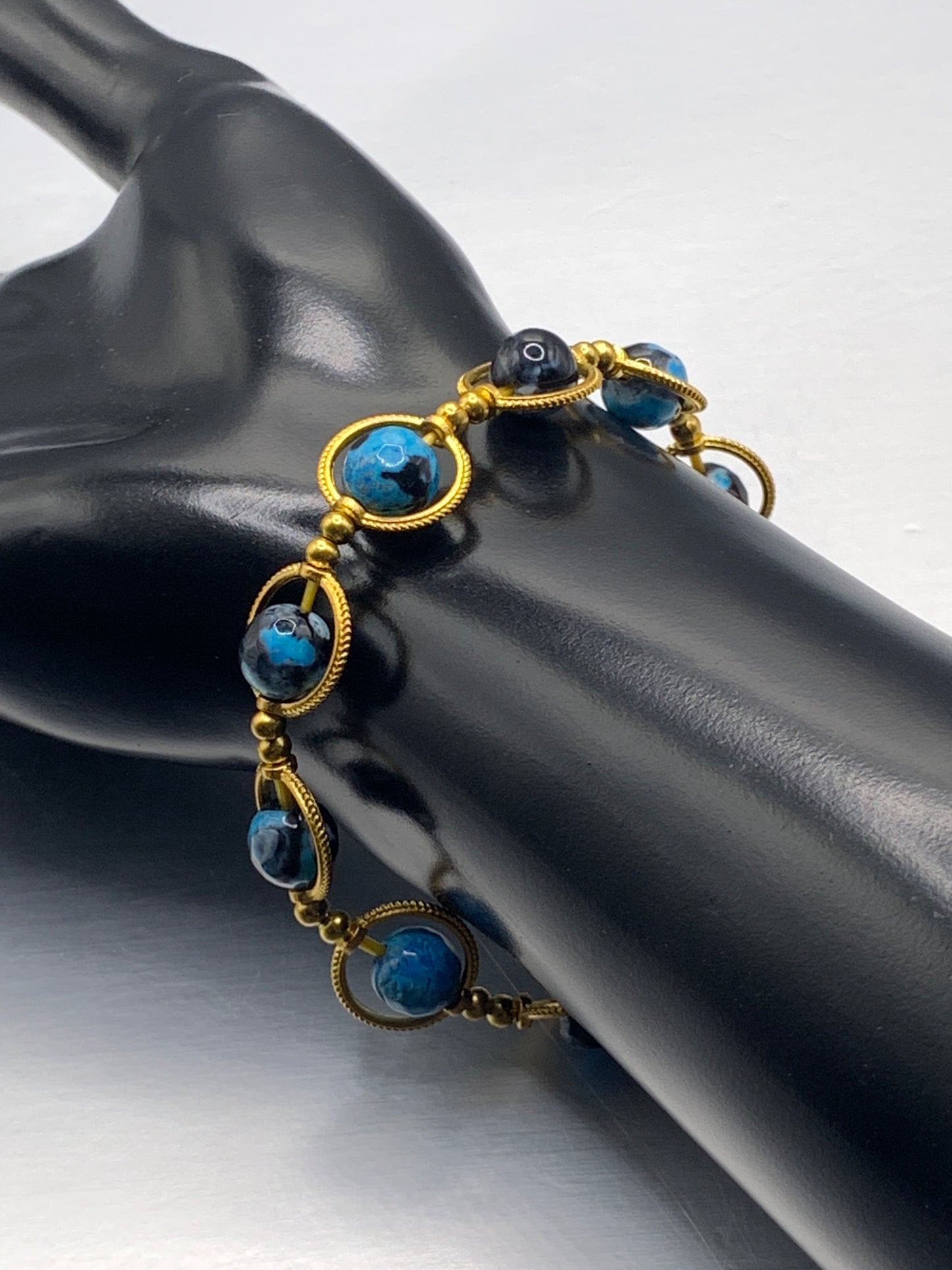 Blue orca agate semi precious stone/crystal elastic beaded bracelet with gold colored rings