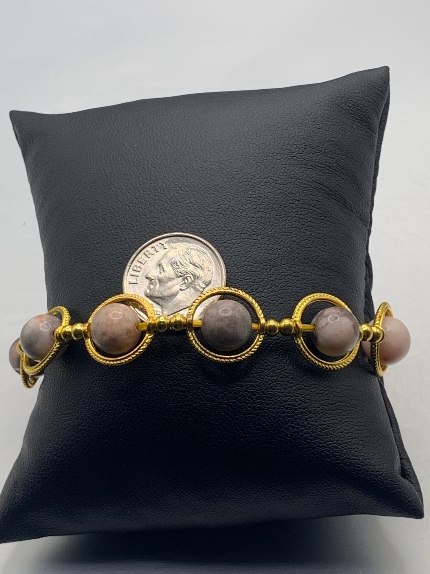 Pink zebra jasper semi precious stone/crystal elastic beaded bracelet with gold colored rings