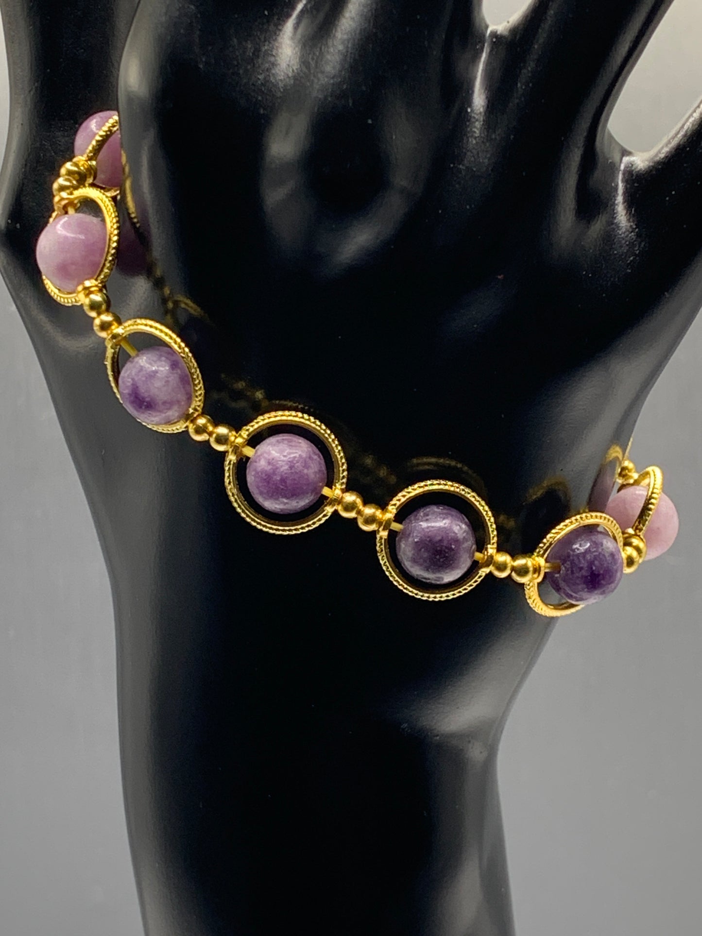 Purple mica semi precious stone/crystal elastic beaded bracelet with gold colored rings