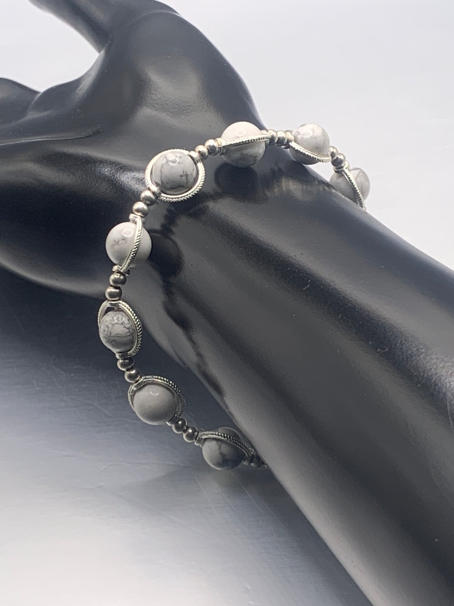 Howlite semi precious stone/crystal elastic beaded bracelet with silver colored rings