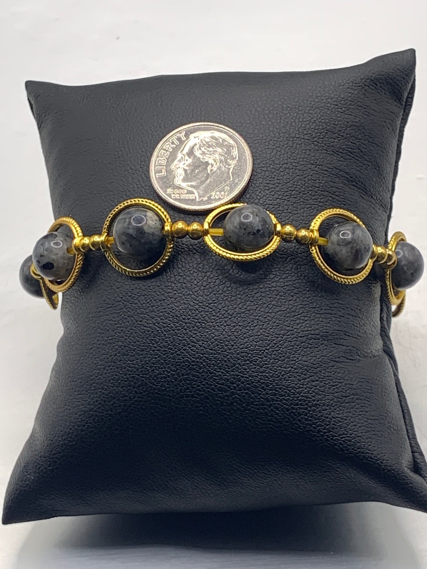 Larvikite semi precious stone/crystal elastic beaded bracelet with gold colored rings