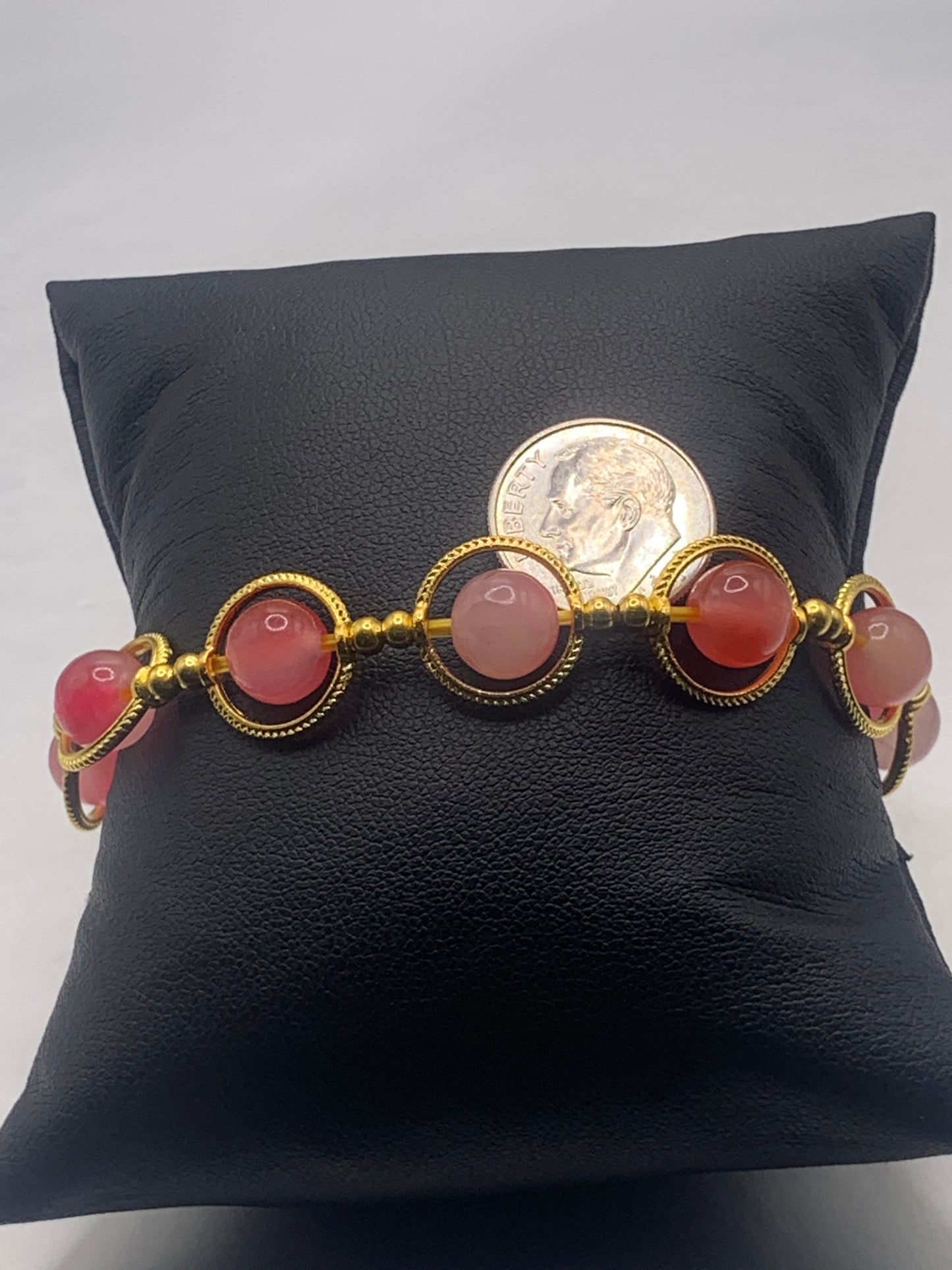 Hot pink agate semi precious stone/crystal elastic beaded bracelet with gold colored rings