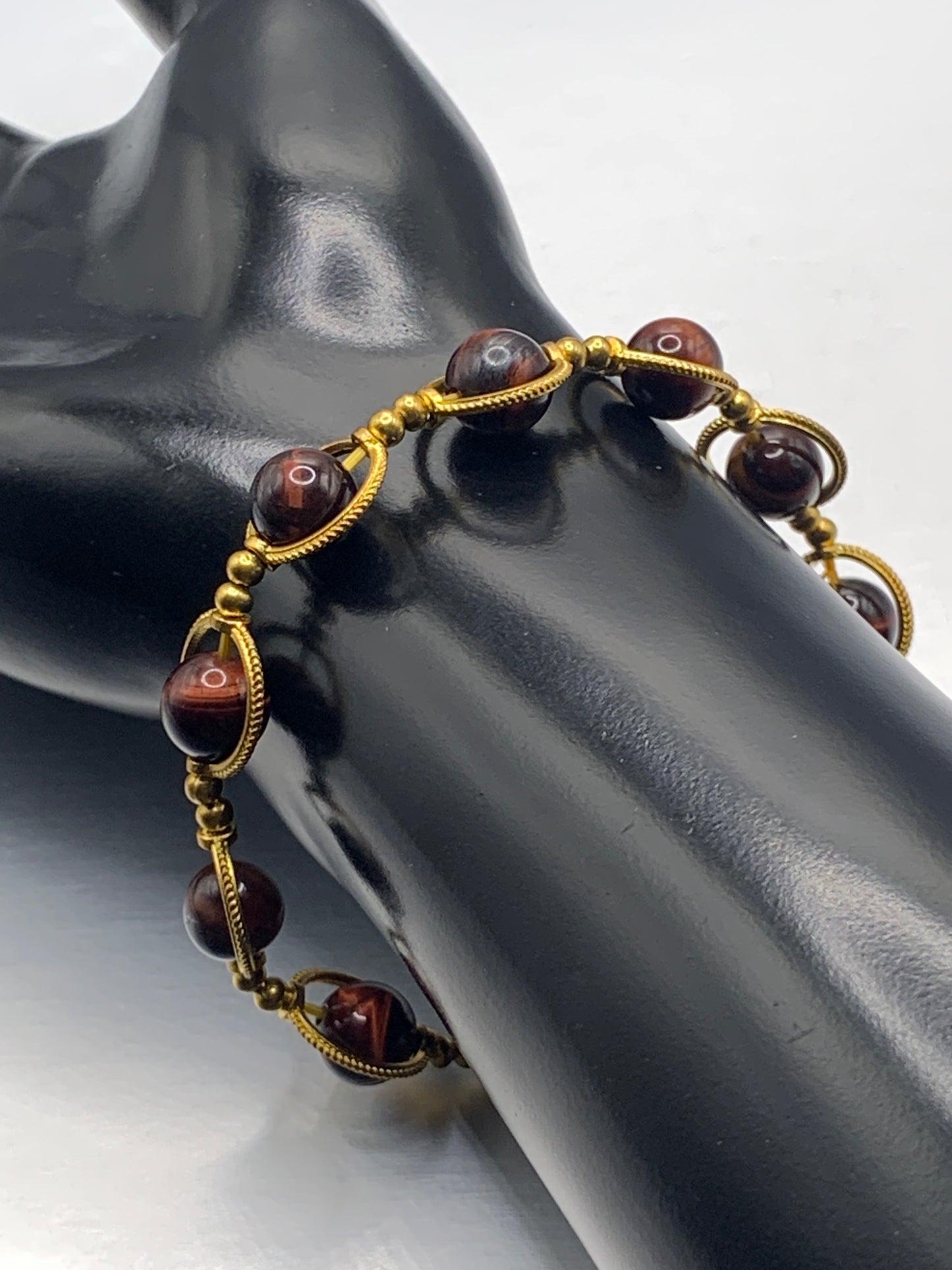 Red tigers eye semi precious stone/crystal elastic beaded bracelet with gold colored rings