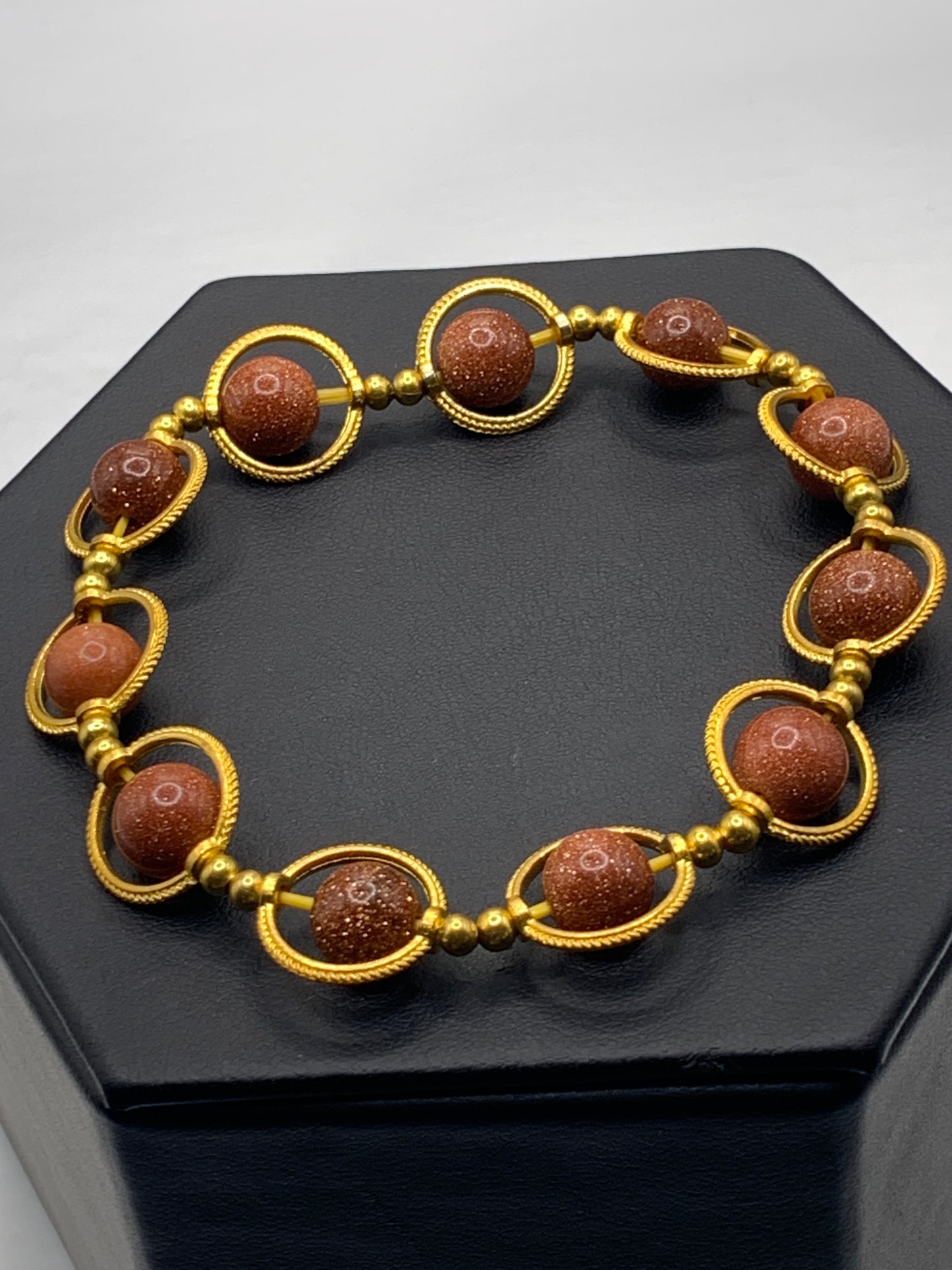 Sandstone semi precious stone/crystal elastic beaded bracelet with gold colored rings