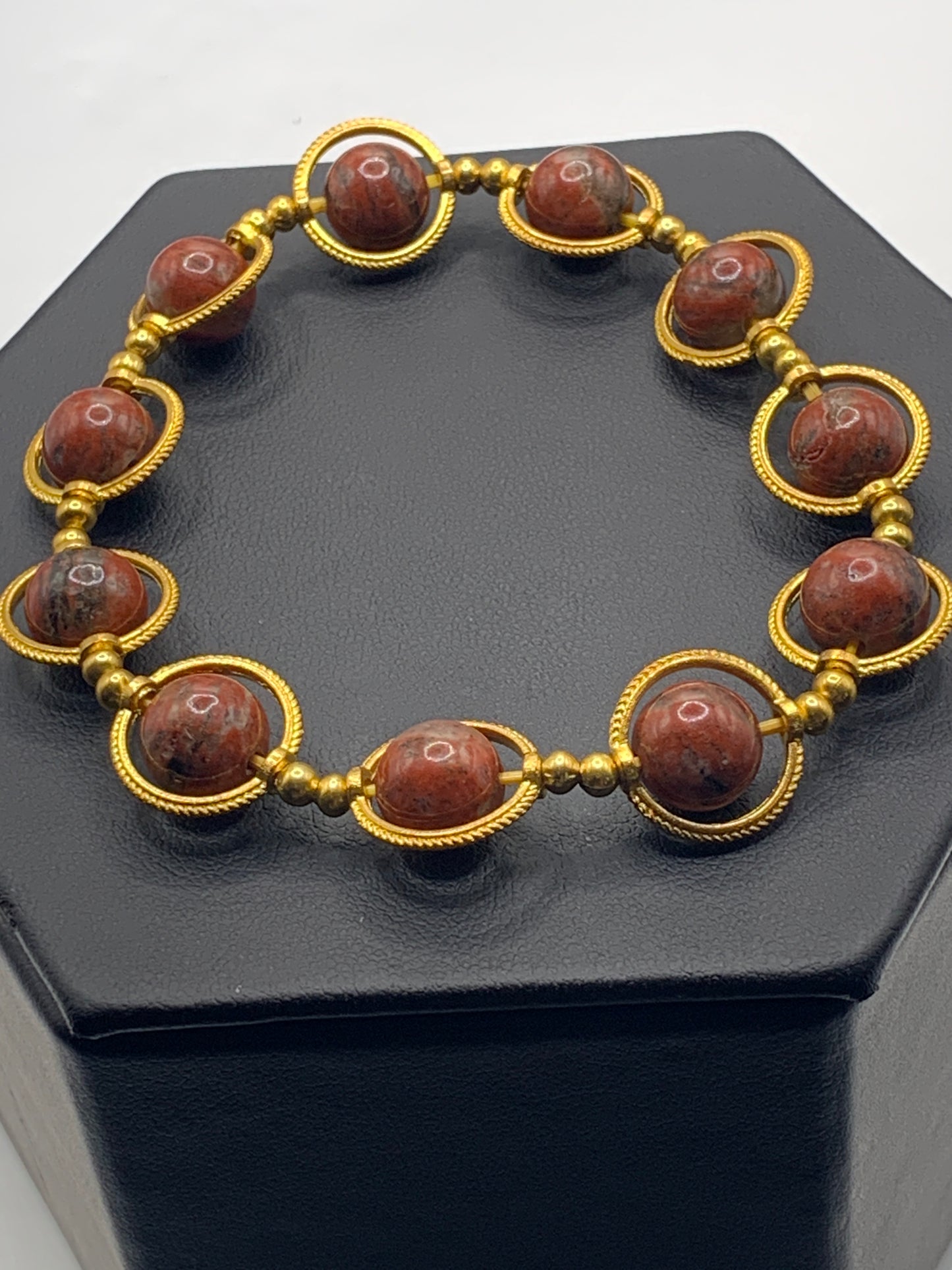 Red sesame jasper semi precious stone/crystal elastic beaded bracelet with gold colored rings