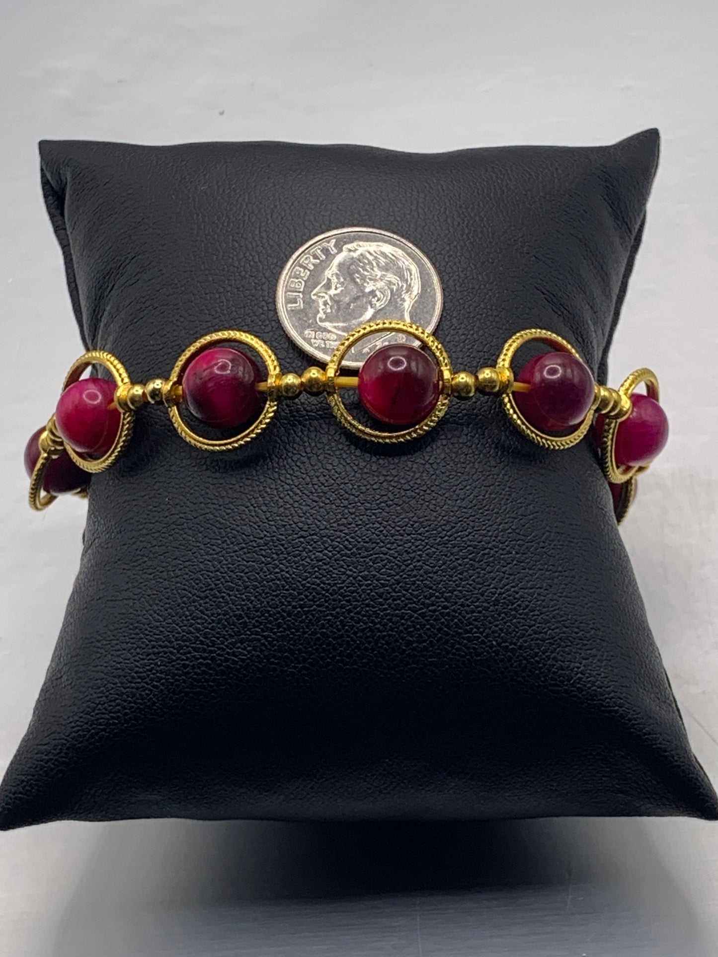 Pink tigers eye semi precious stone/crystal elastic beaded bracelet with gold colored rings