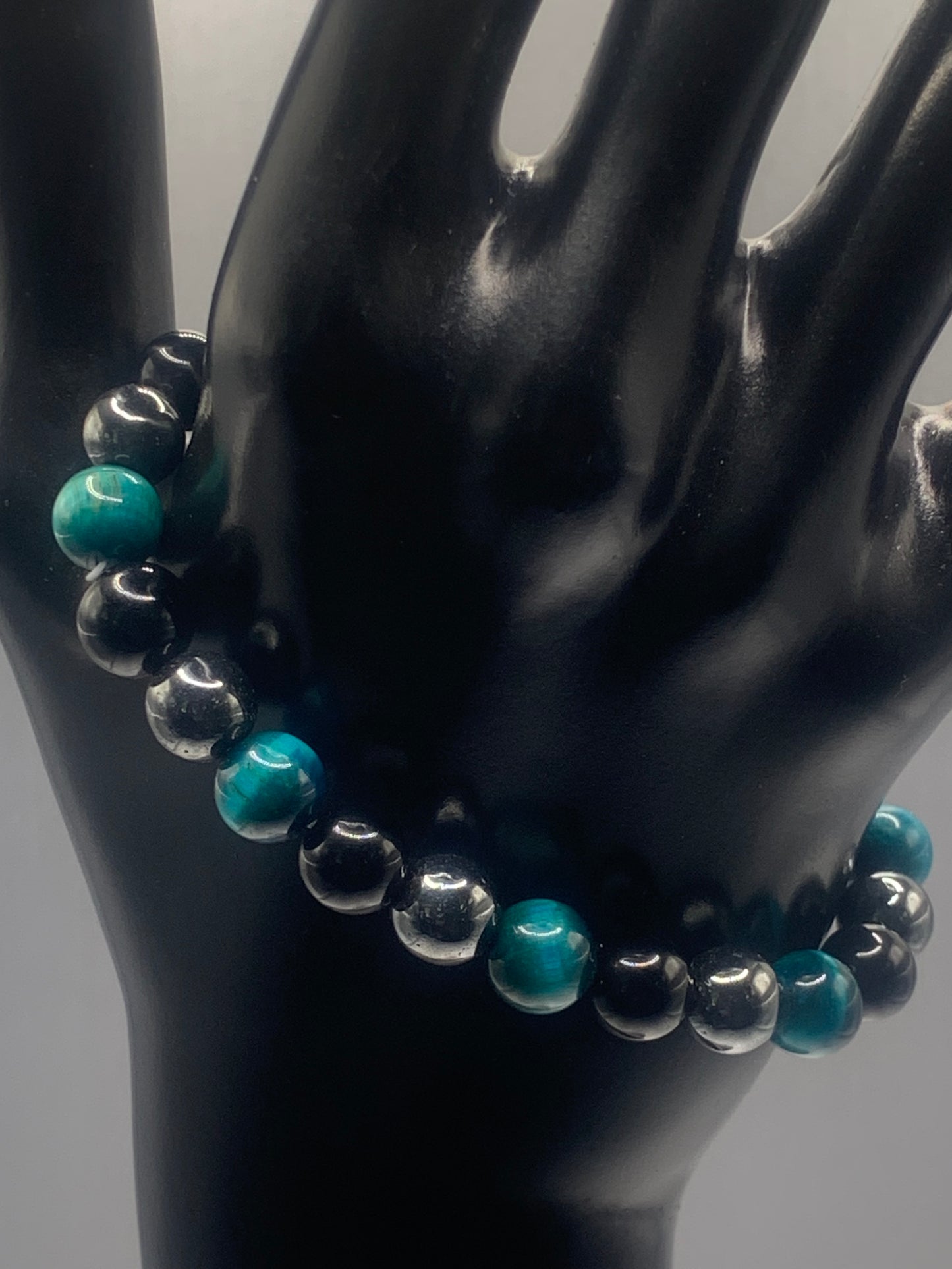 Hematite, black obsidian, and teal blue tigers eye semi precious stone/crystal elastic beaded bracelet
