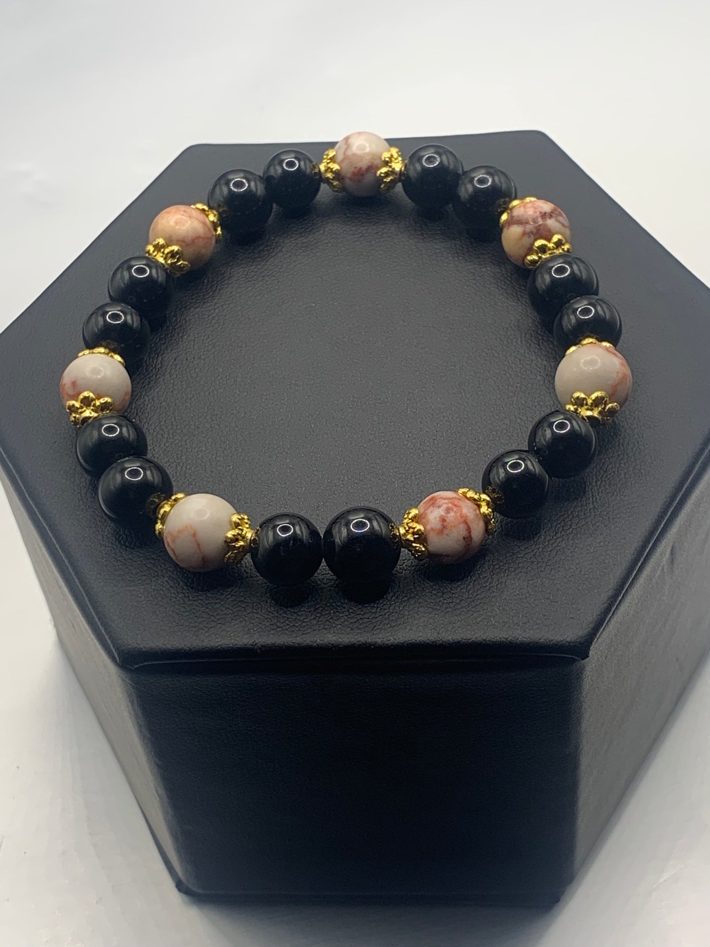 Red vein jasper and black obsidian semi precious stone/crystal elastic beaded bracelet with gold plated flower bead caps