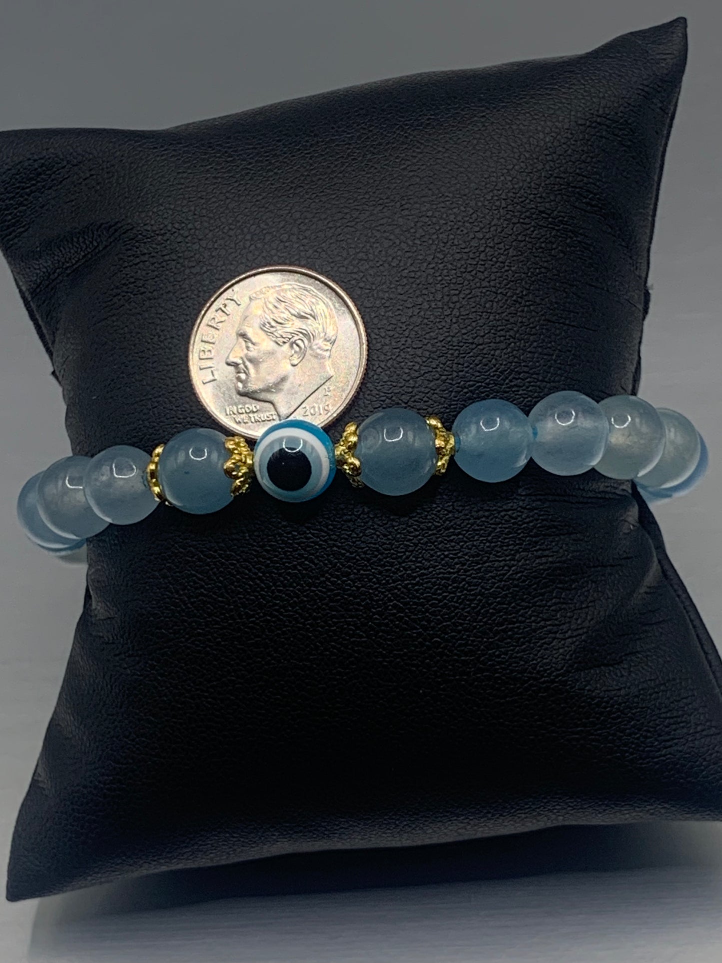 This bracelet features blue agate beads and a colorful evil eye resin bead with gold flower caps. These are 8mm beads, made with elastic string to stretch onto the wrist and is approximately 17 cm or 6.7 inches
These are natural semi-precious stones/crystals. Even if they are dyed, the base material is still natural and imperfections are common making them unique