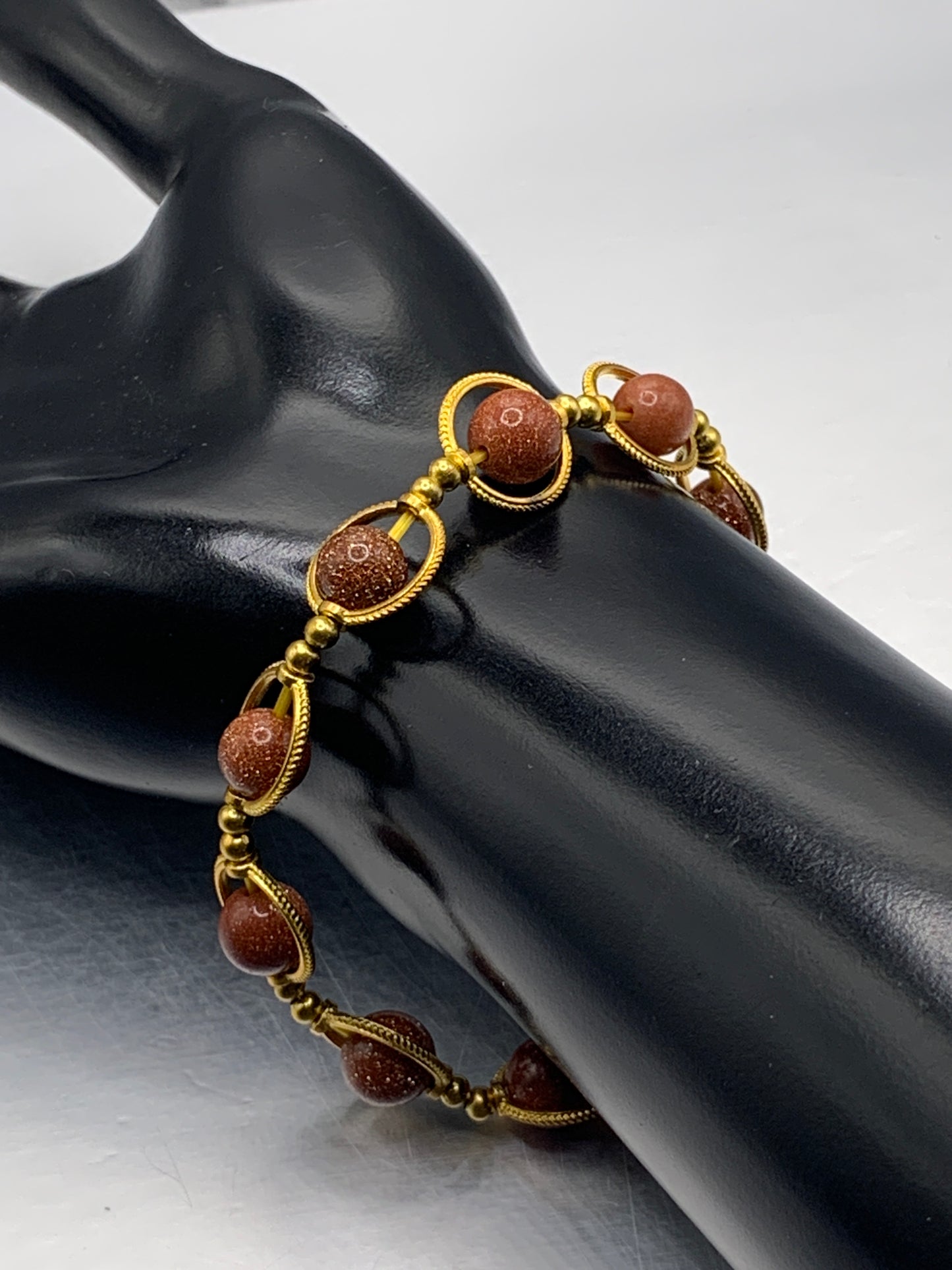 Sandstone semi precious stone/crystal elastic beaded bracelet with gold colored rings