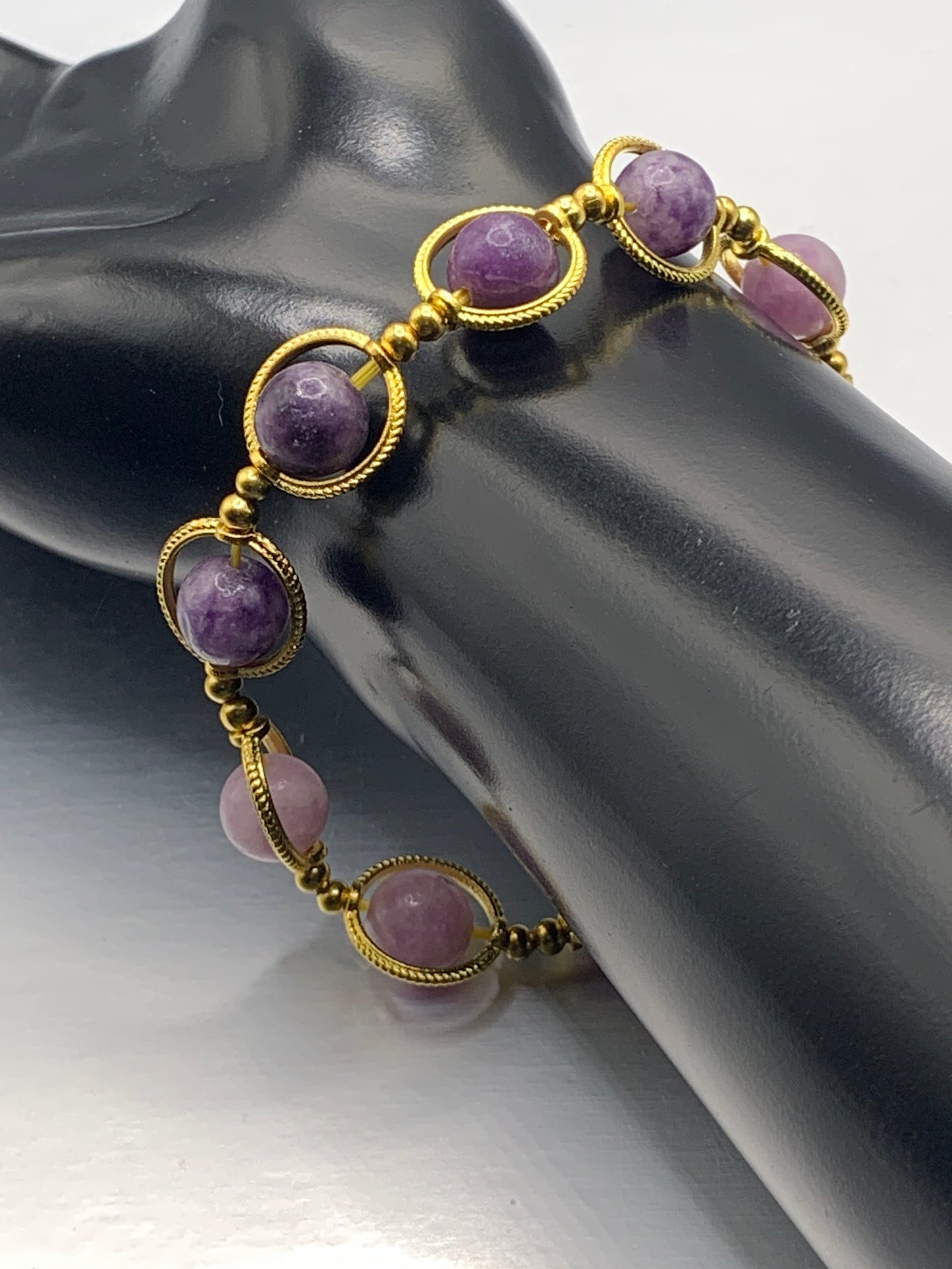 Purple mica semi precious stone/crystal elastic beaded bracelet with gold colored rings