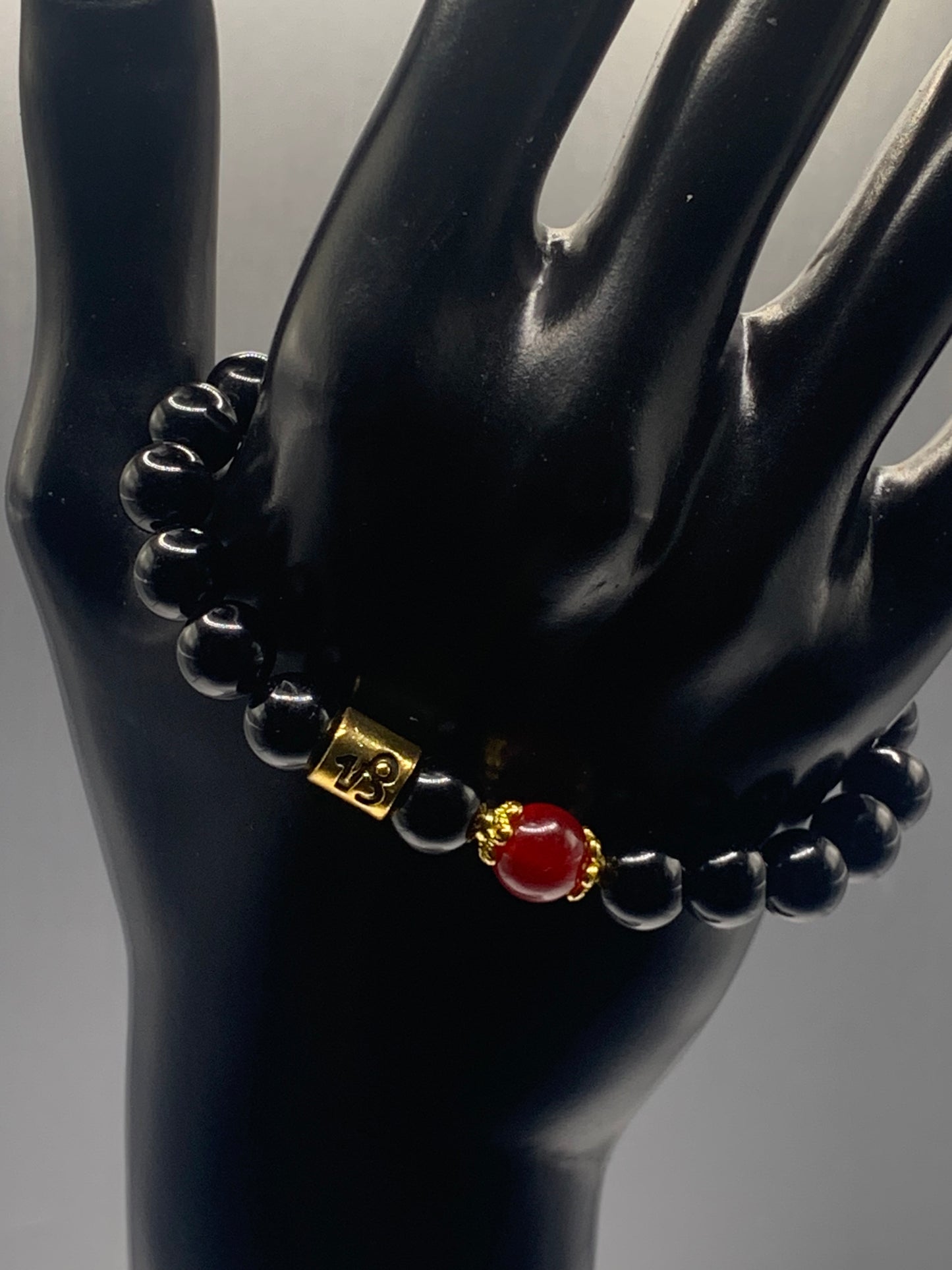 Capricorn Zodiac black obsidian with red chalcedony elastic beaded bracelet with gold accents
