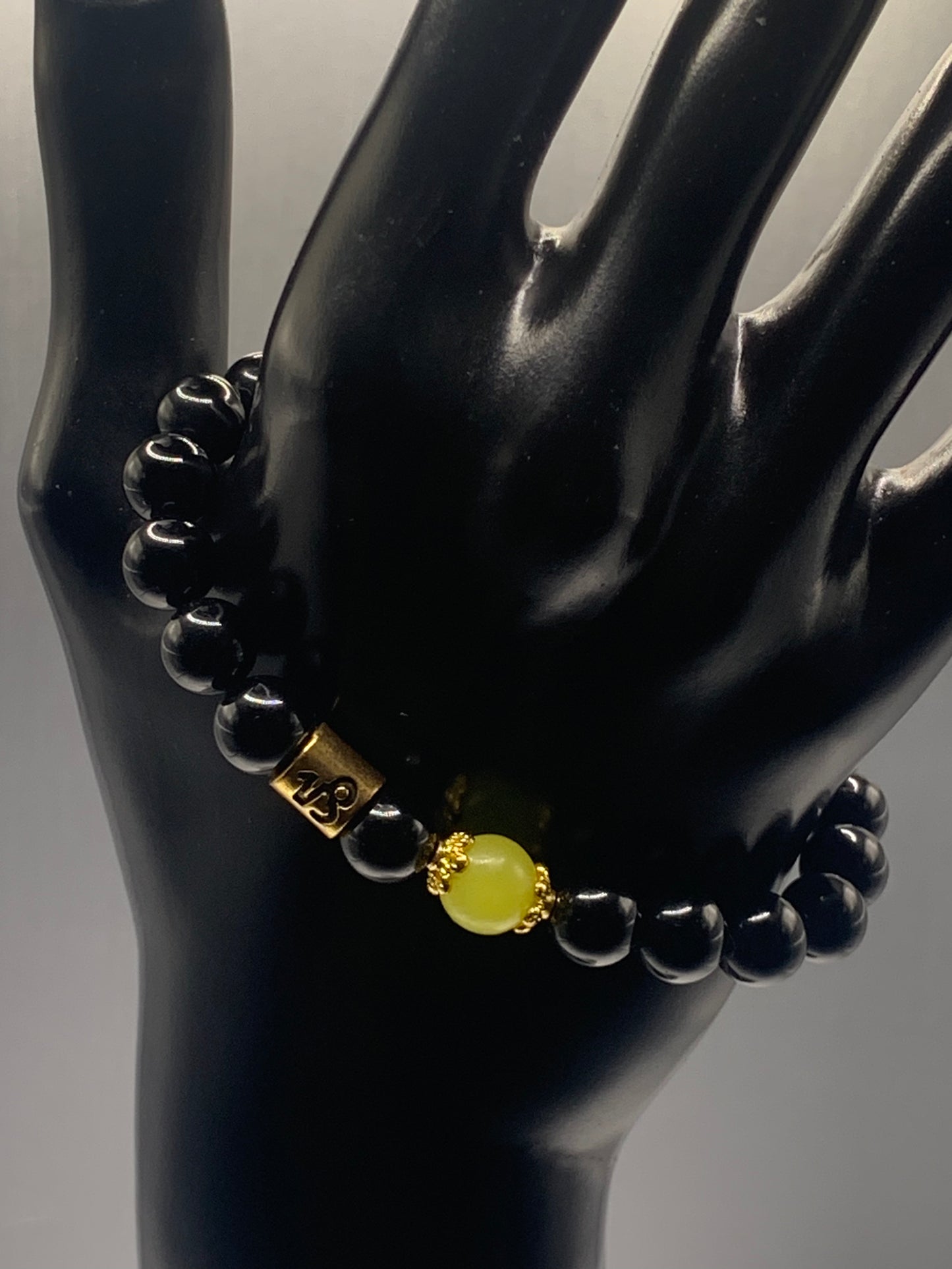 Capricorn Zodiac black obsidian with yellow jade elastic beaded bracelet with gold accents