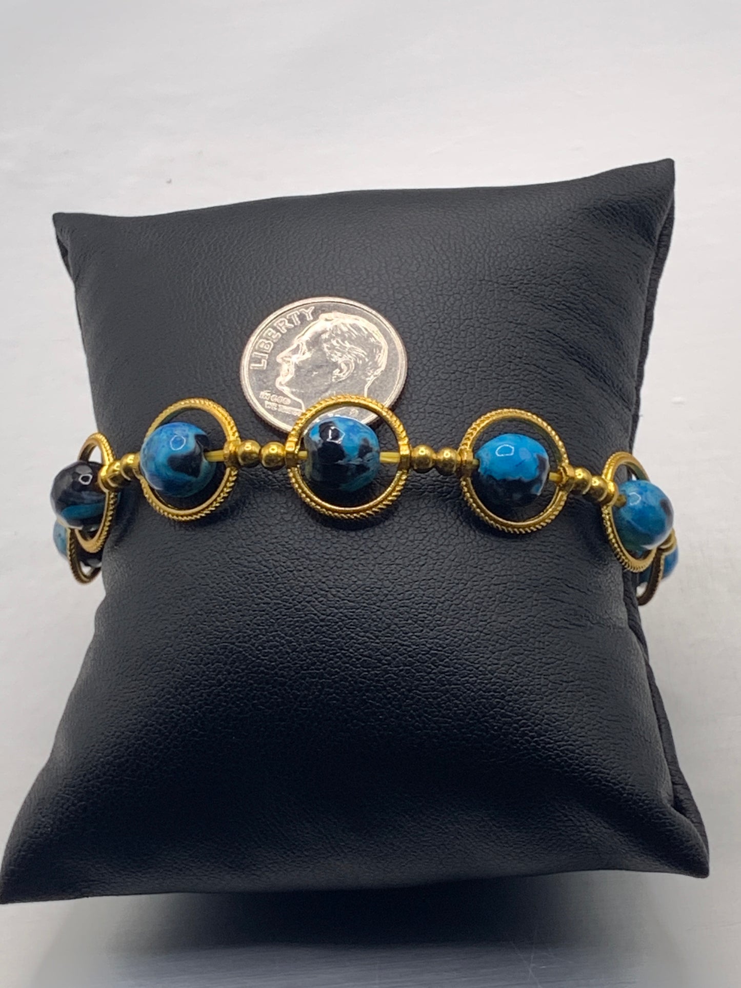 Blue orca agate semi precious stone/crystal elastic beaded bracelet with gold colored rings