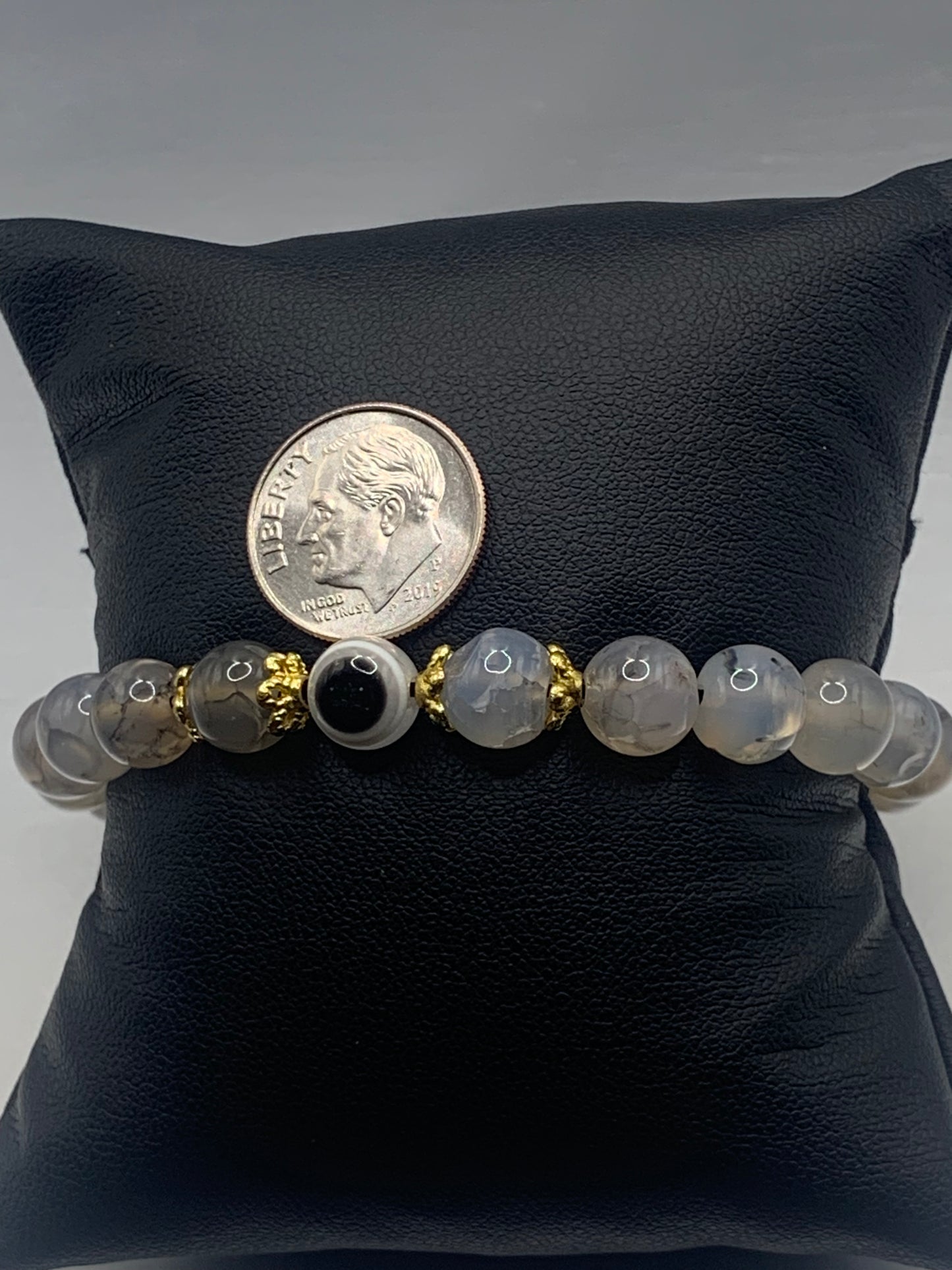 This bracelet features dragon vein agate beads and a colorful evil eye resin bead with gold flower caps. These are 8mm beads, made with elastic string to stretch onto the wrist and is approximately 17 cm or 6.7 inches
These are natural semi-precious stones/crystals. Even if they are dyed, the base material is still natural and imperfections are common making them unique