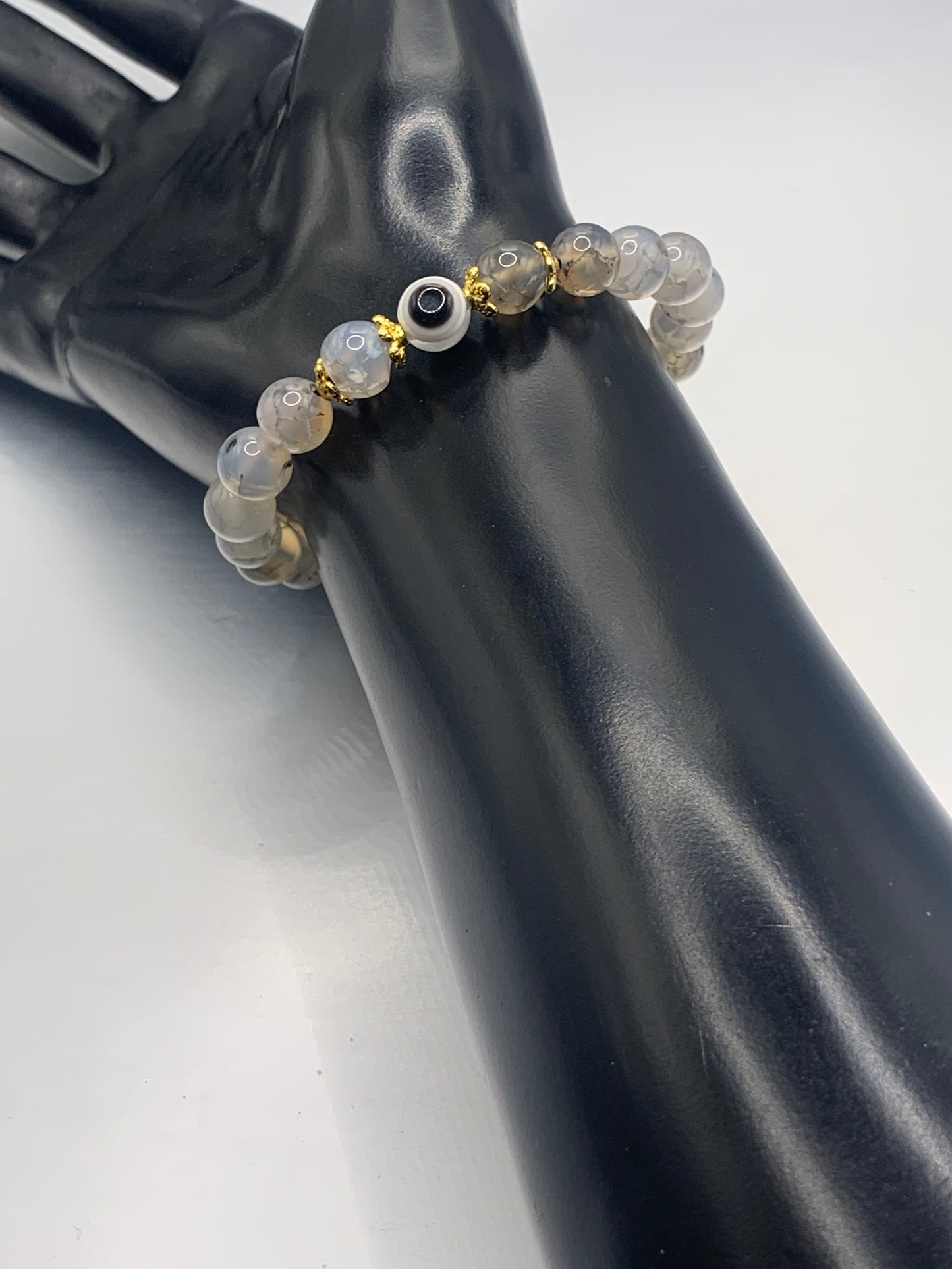 This bracelet features dragon vein agate beads and a colorful evil eye resin bead with gold flower caps. These are 8mm beads, made with elastic string to stretch onto the wrist and is approximately 17 cm or 6.7 inches
These are natural semi-precious stones/crystals. Even if they are dyed, the base material is still natural and imperfections are common making them unique