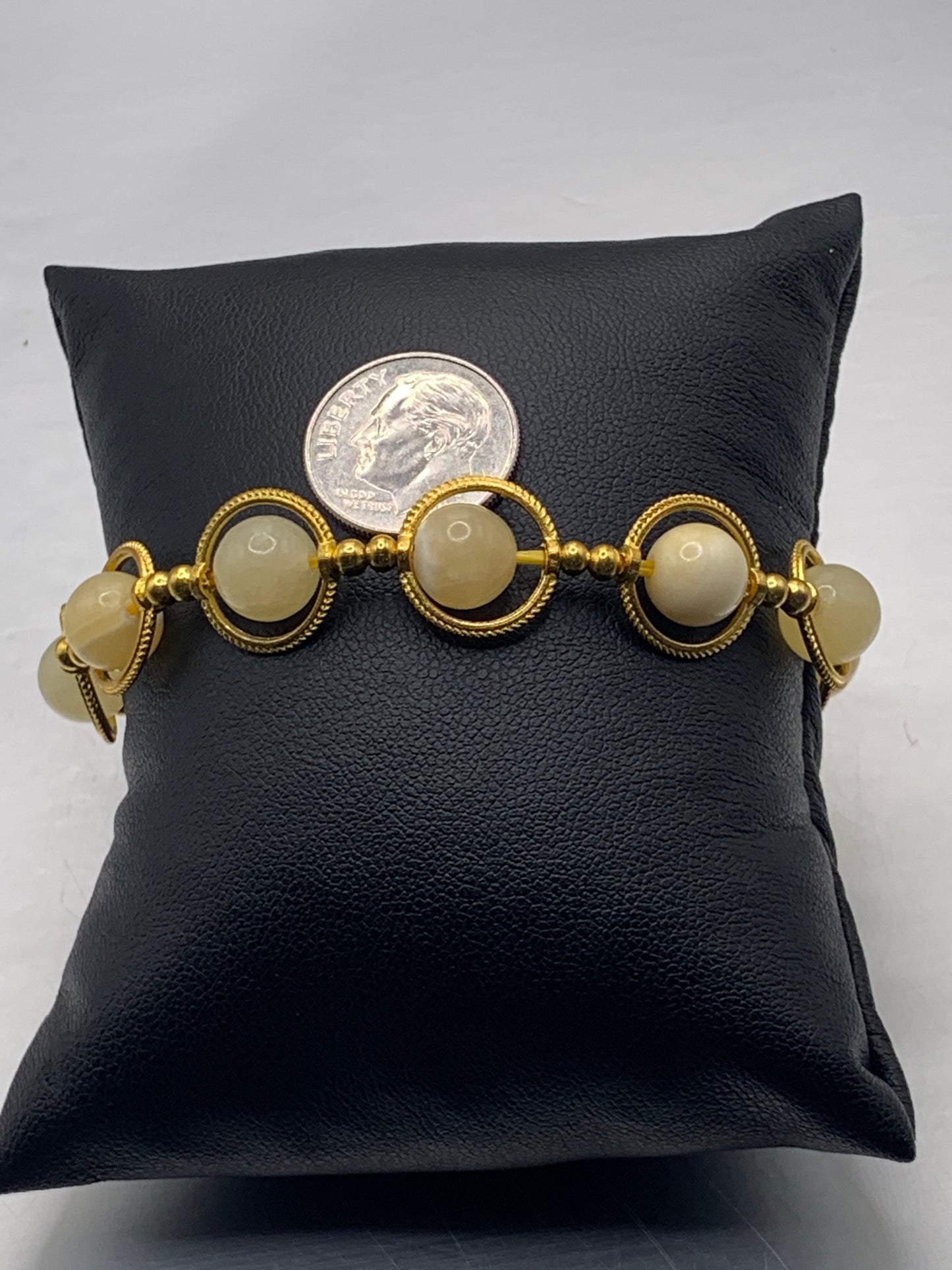 Yellow calcite semi precious stone/crystal elastic beaded bracelet with gold colored rings