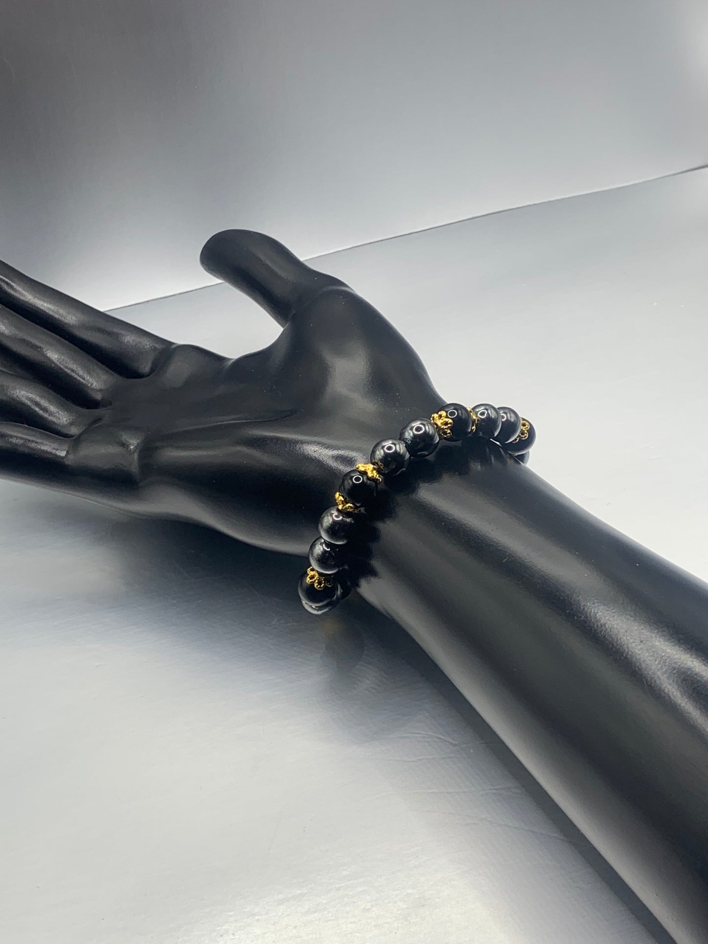 Black obsidian with hematite semi precious stone/crystal beaded elastic bracelet with gold plated flower bead caps