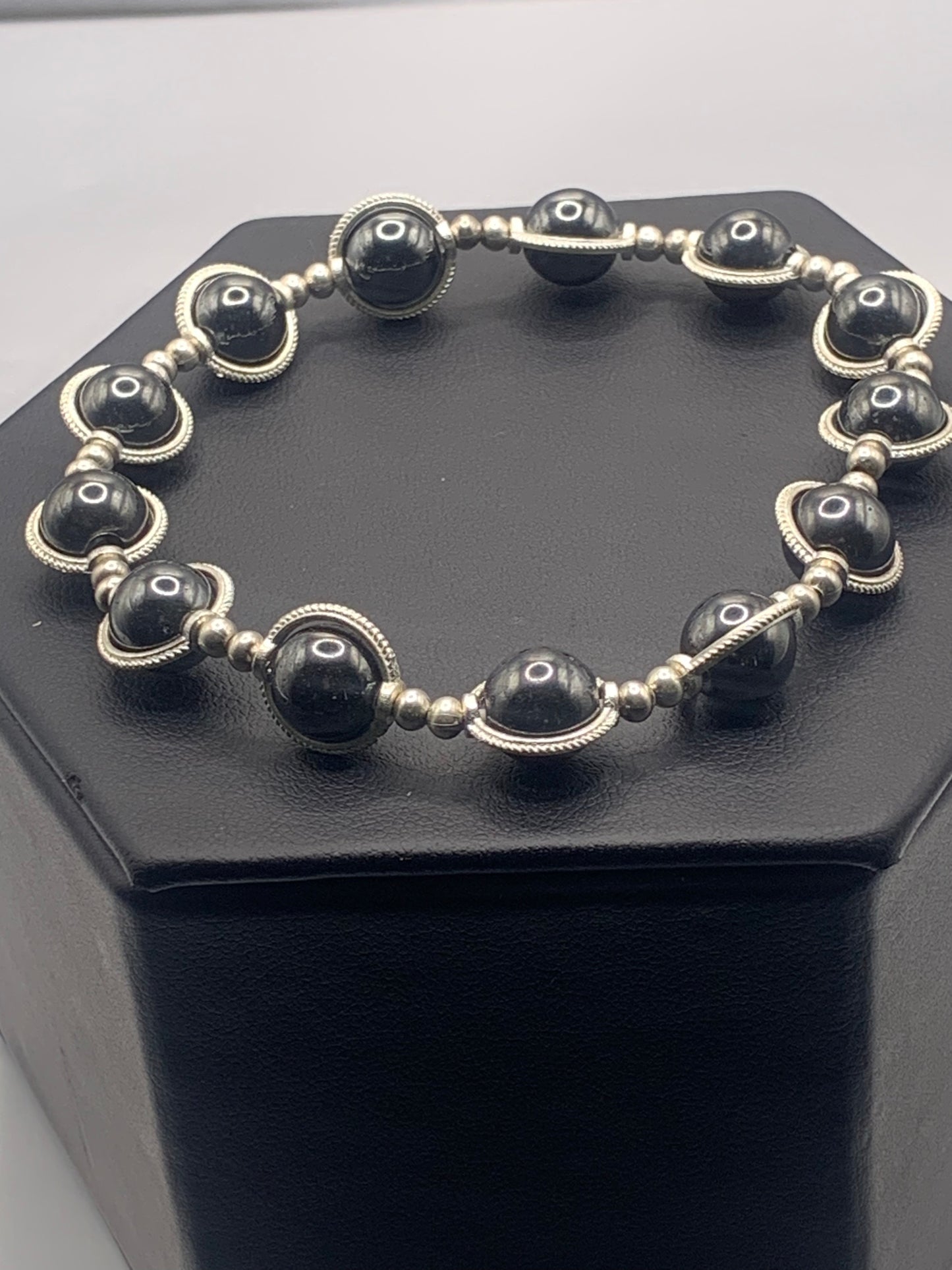 Hematite semi precious stone/crystal elastic beaded bracelet with silver colored rings