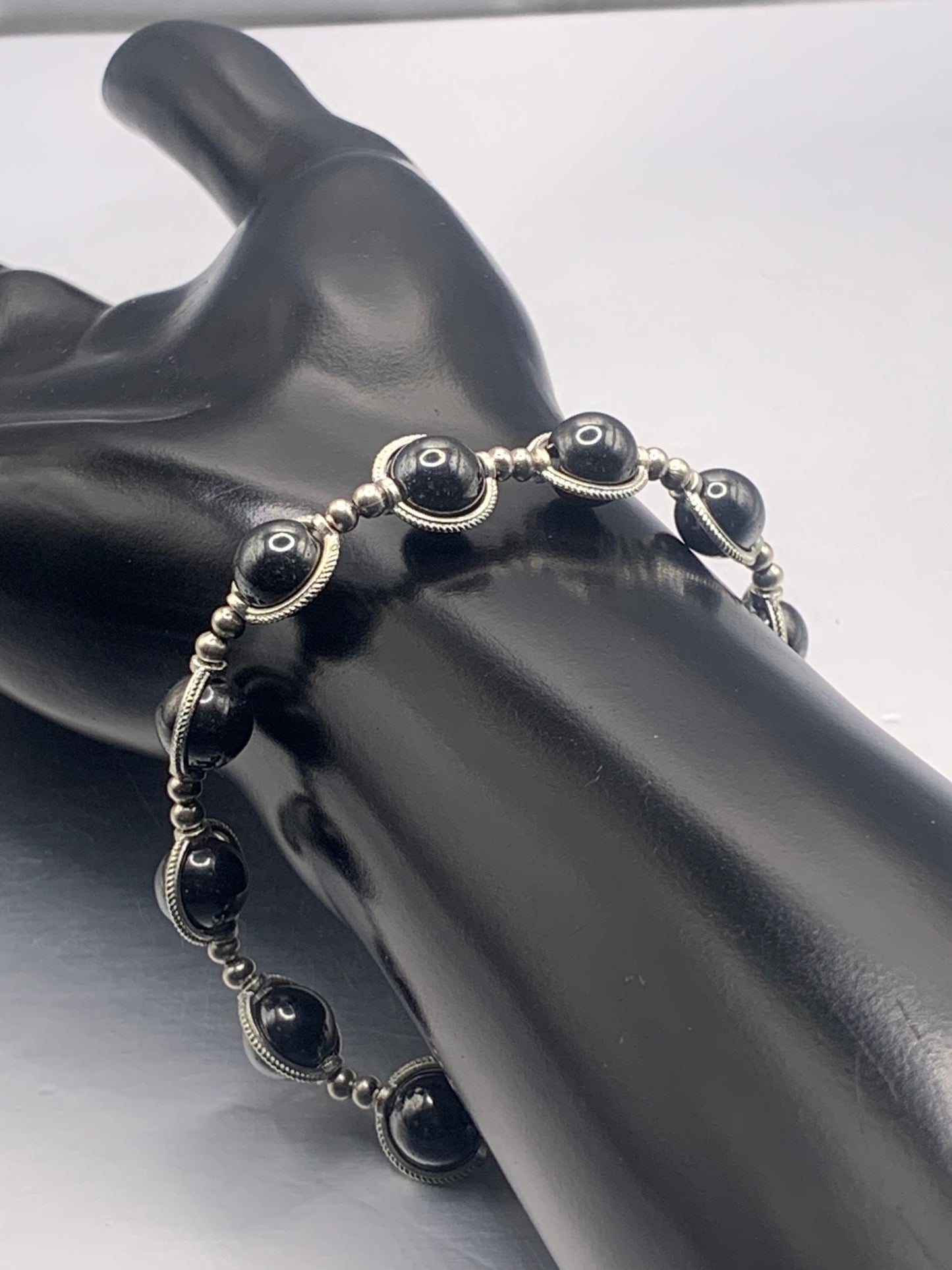 Hematite semi precious stone/crystal elastic beaded bracelet with silver colored rings