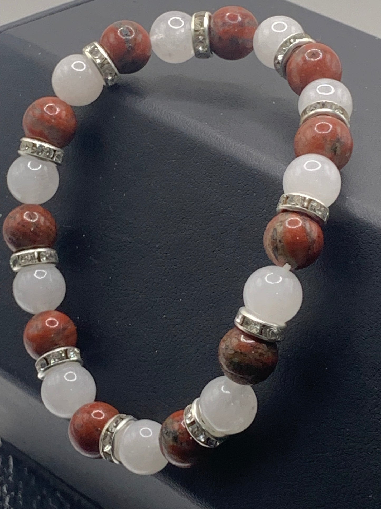 Red sesame jasper and white chalcedony semi precious stone/crystal elastic beaded bracelet with clear rondelle's