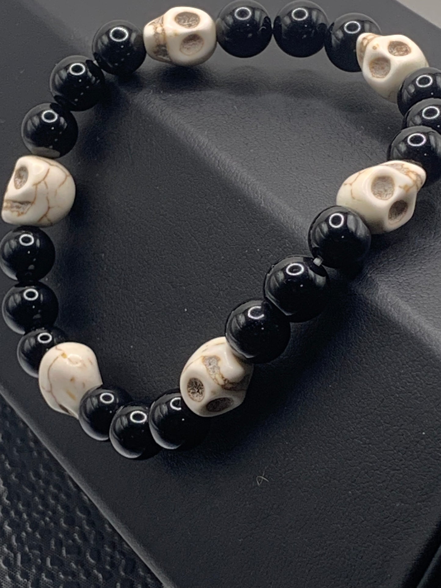 Black obsidian semi precious stone/crystal elastic beaded bracelet with white resin skulls