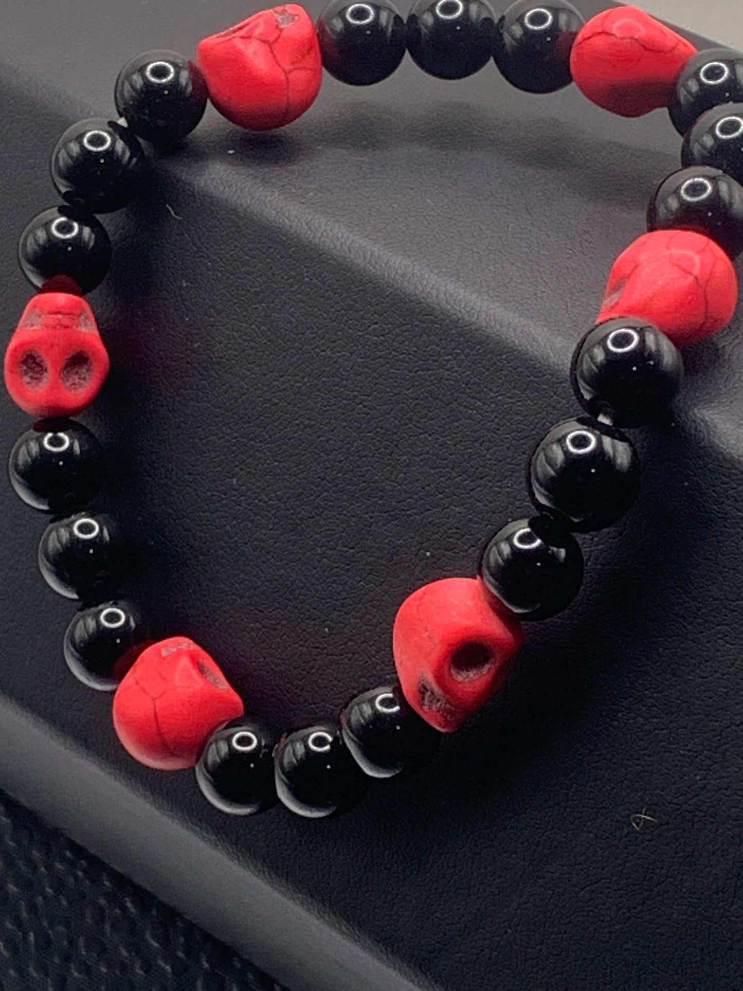 Black obsidian semi precious stone/crystal elastic beaded bracelet with pink resin skulls