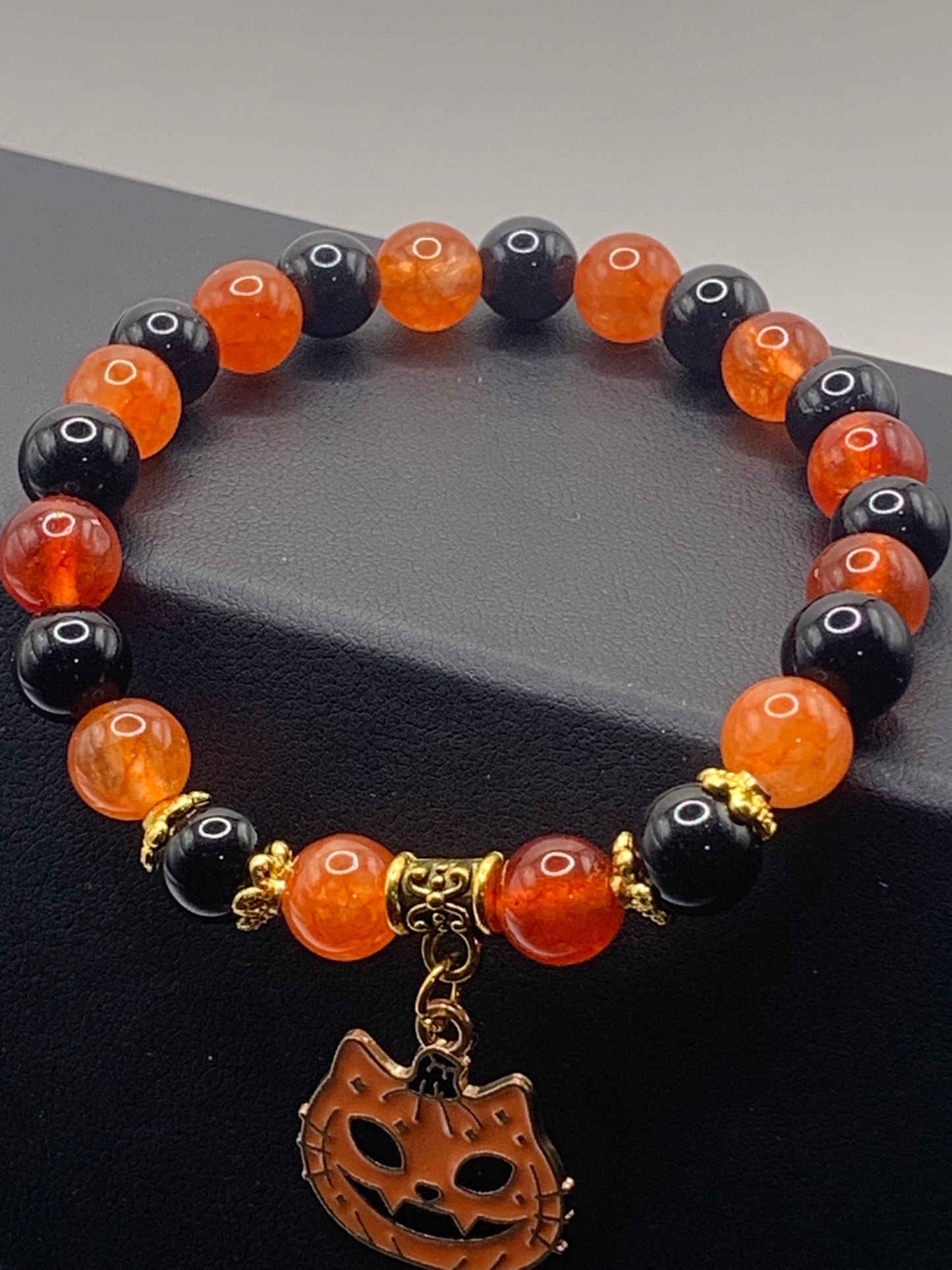 Phoenix agate, and black obsidian semi precious stone/crystal elastic beaded bracelet with Halloween charm