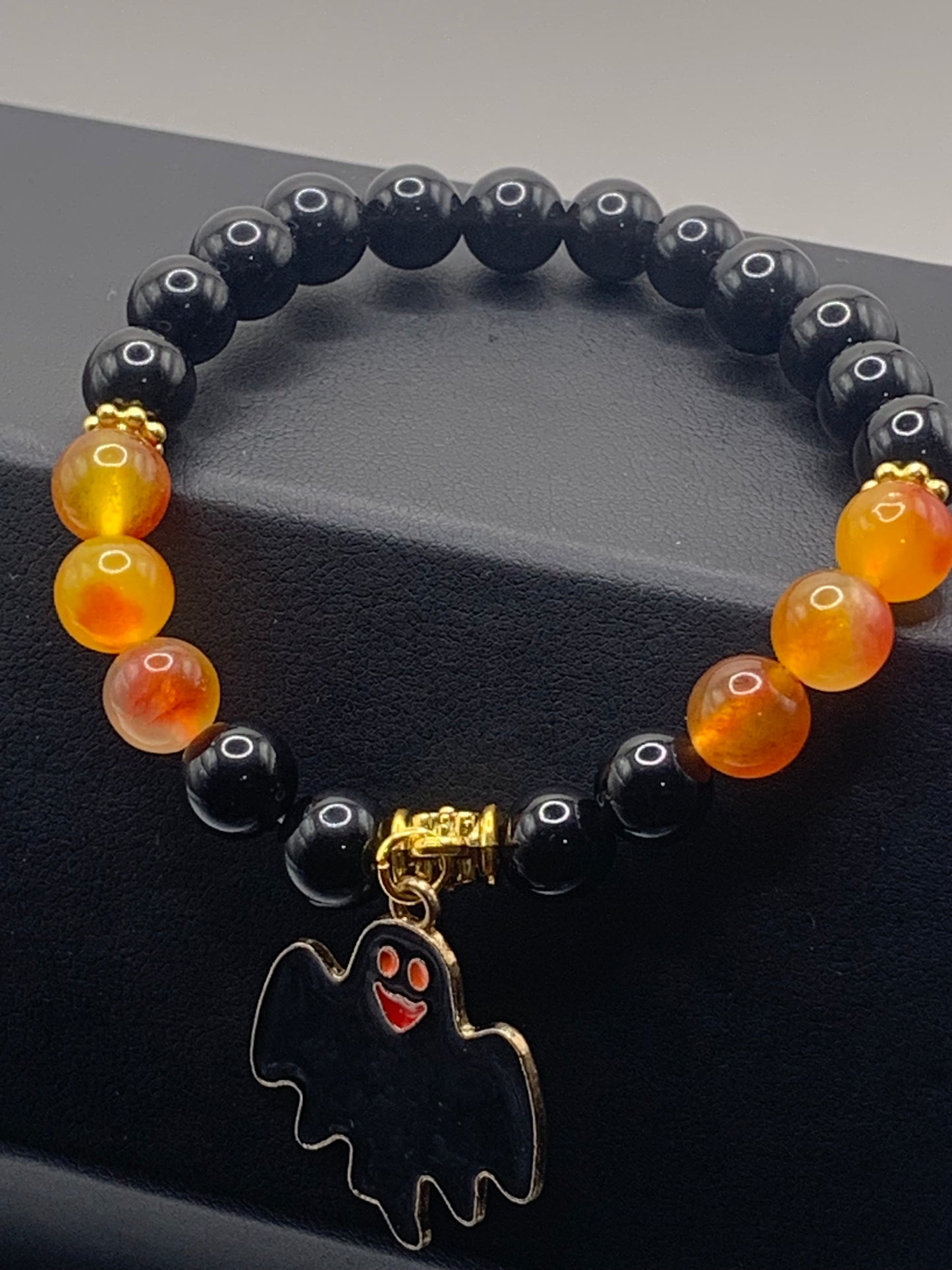 Black obsidian and orange blossom chalcedony semi precious stone/crystal elastic beaded bracelet with Halloween charm