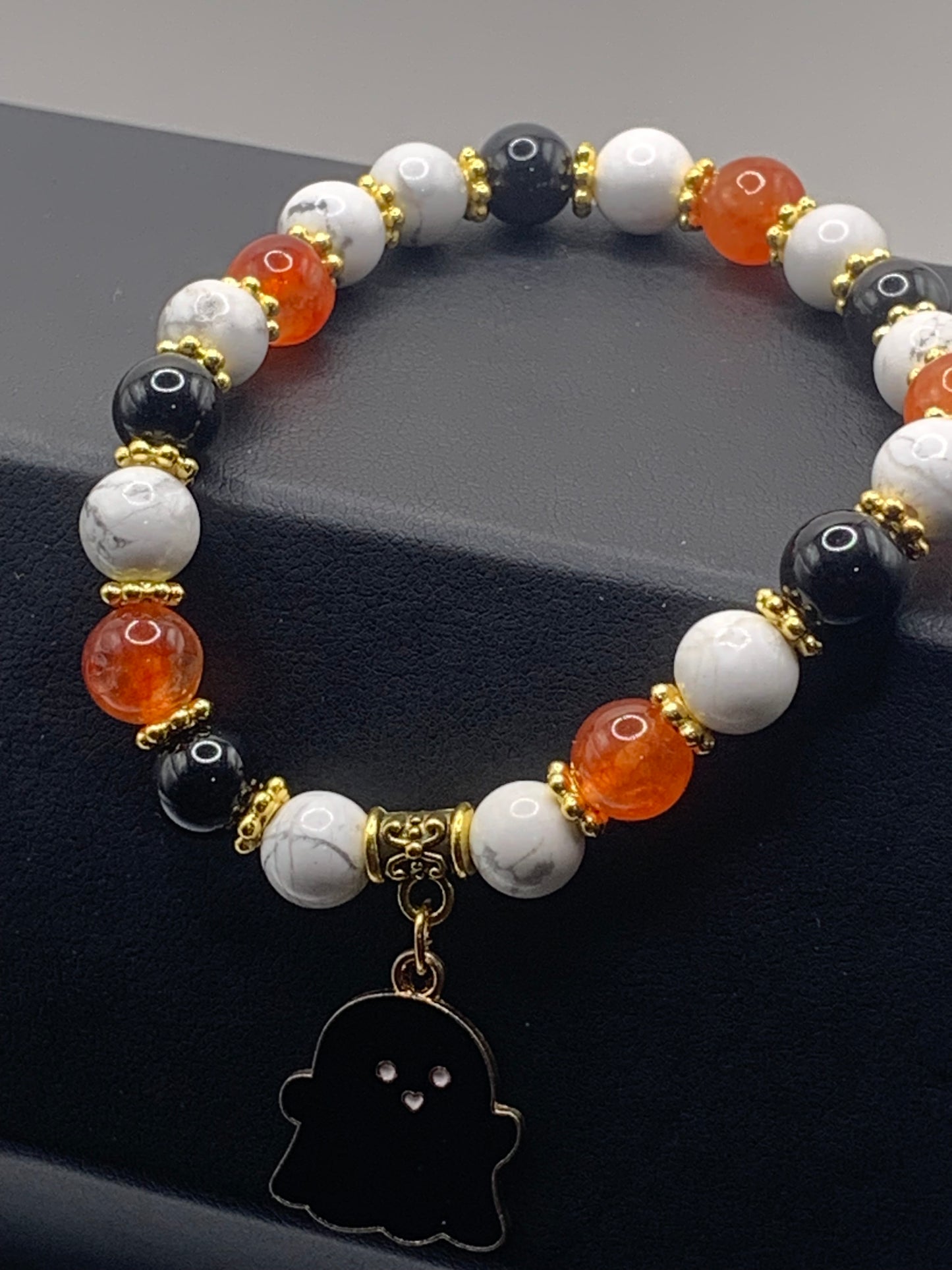 Howlite, black obsidian and phoenix agate semi precious stone/crystal elastic beaded bracelet with Halloween charm