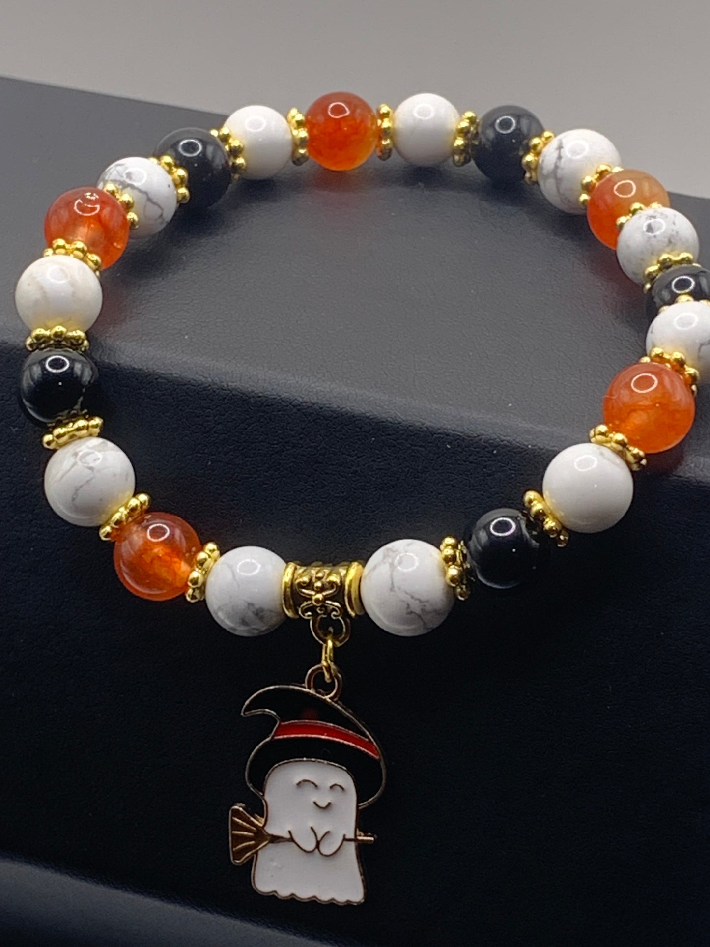Black obsidian, howlite, and phoenix agate semi precious stone/crystal elastic beaded bracelet with Halloween charm