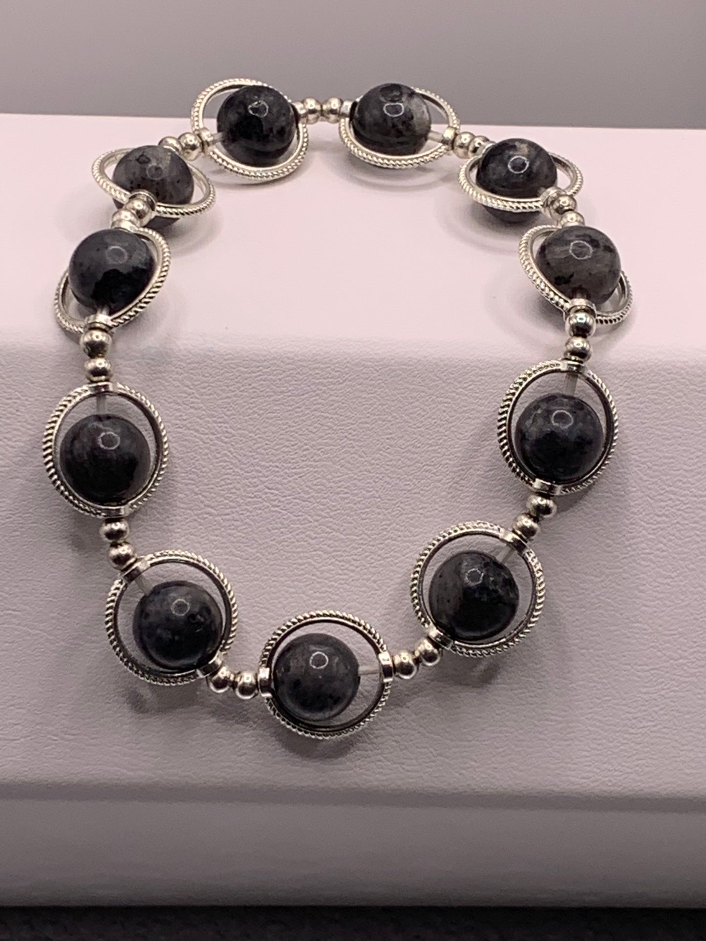 Larvikite semi precious stone/crystal elastic beaded bracelet with silver colored rings
