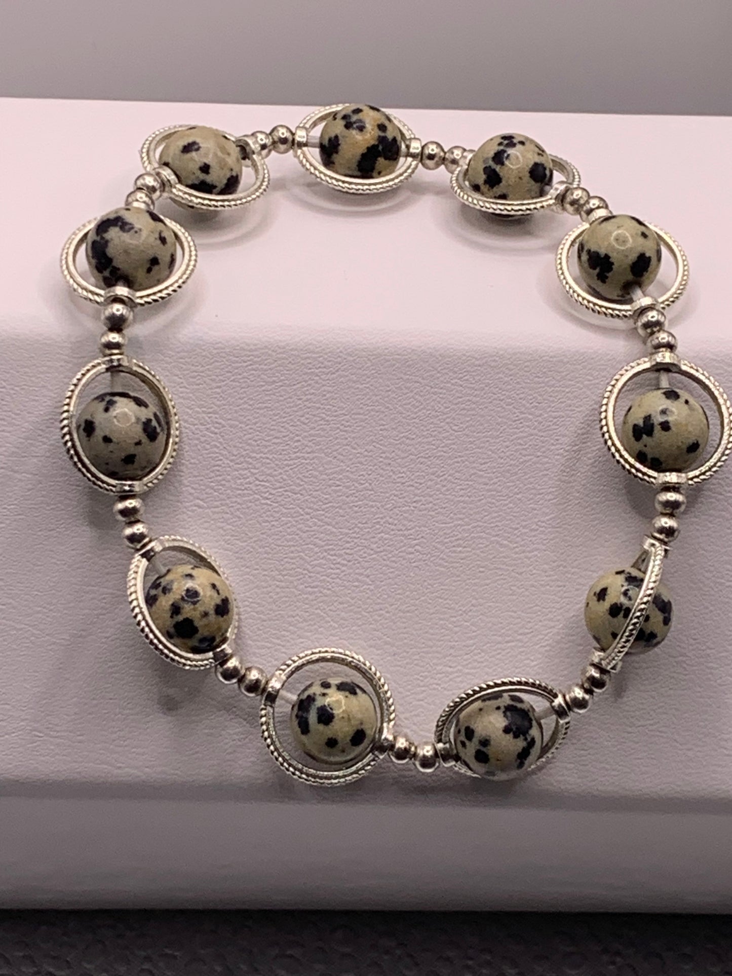 Dalmatian jasper semi precious stone/crystal elastic beaded bracelet with silver colored rings