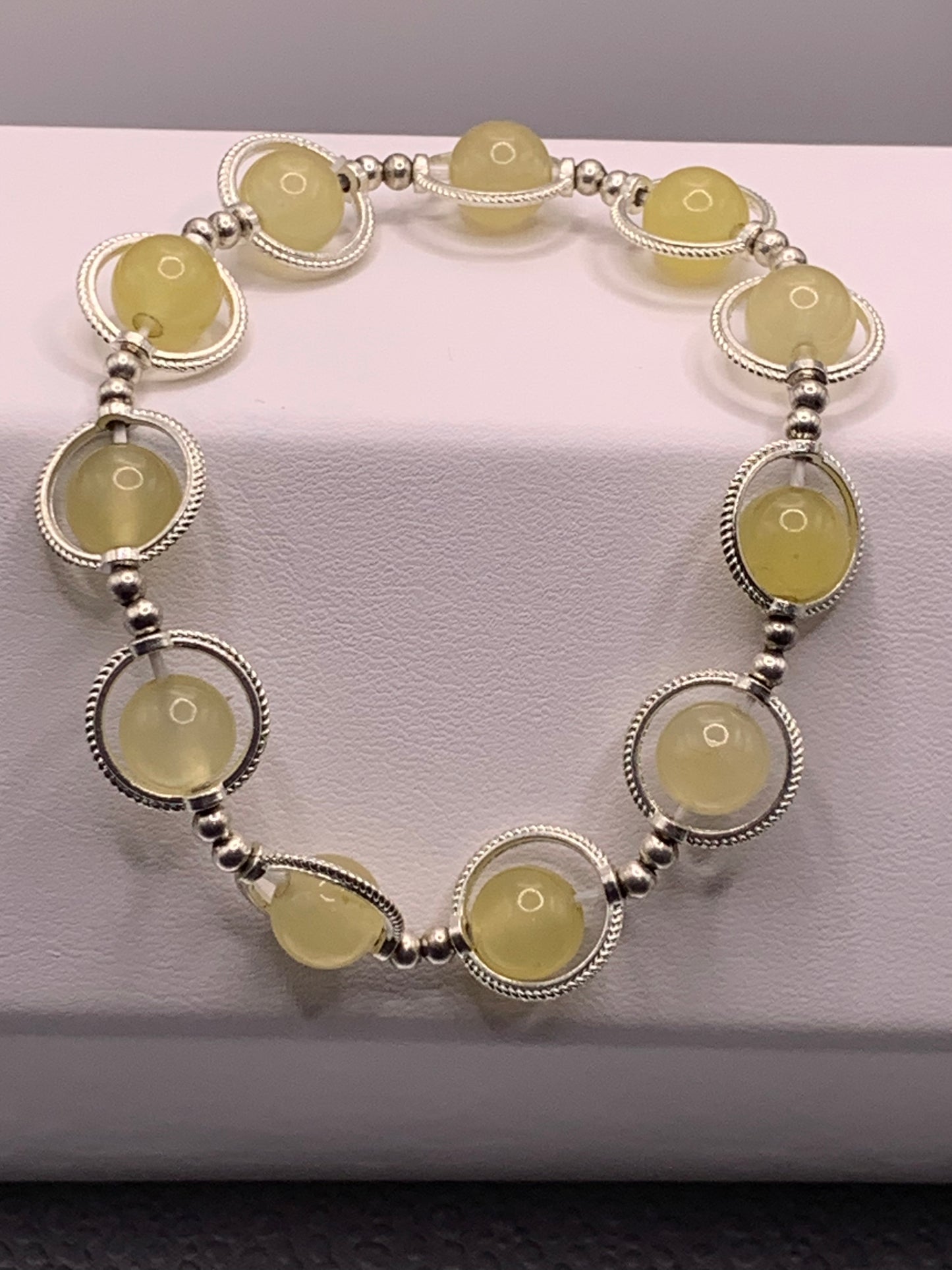 Yellow agate semi precious stone/crystal elastic beaded bracelet with silver colored rings