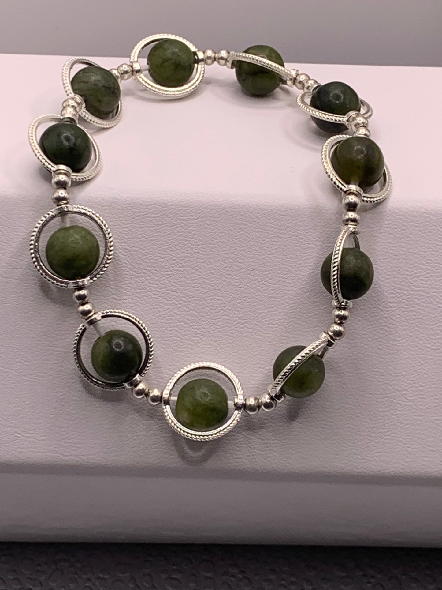 Green jade semi precious stone/crystal elastic beaded bracelet with silver colored rings