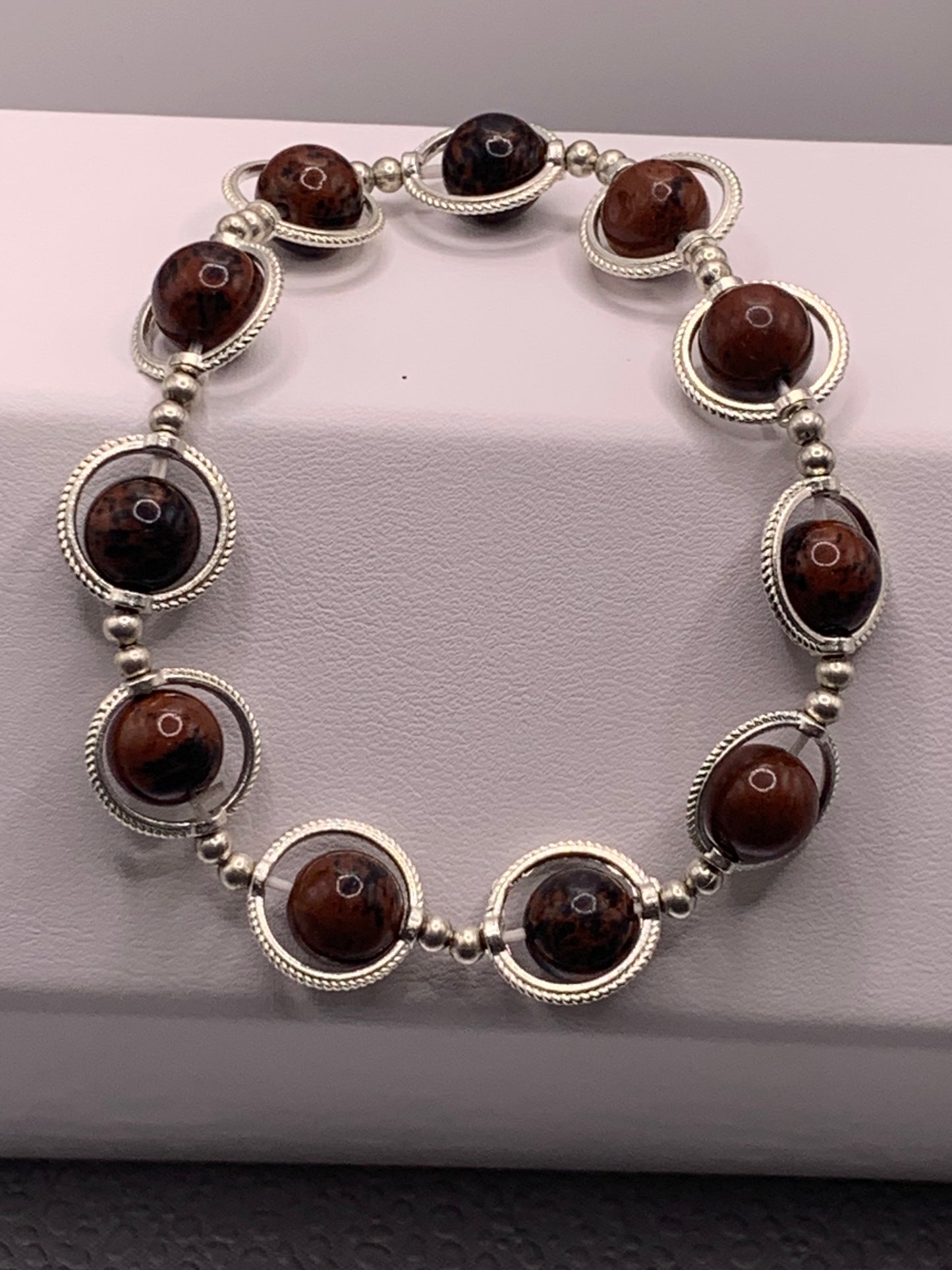 Mahogany jasper semi precious stone/crystal elastic beaded bracelet with silver colored rings